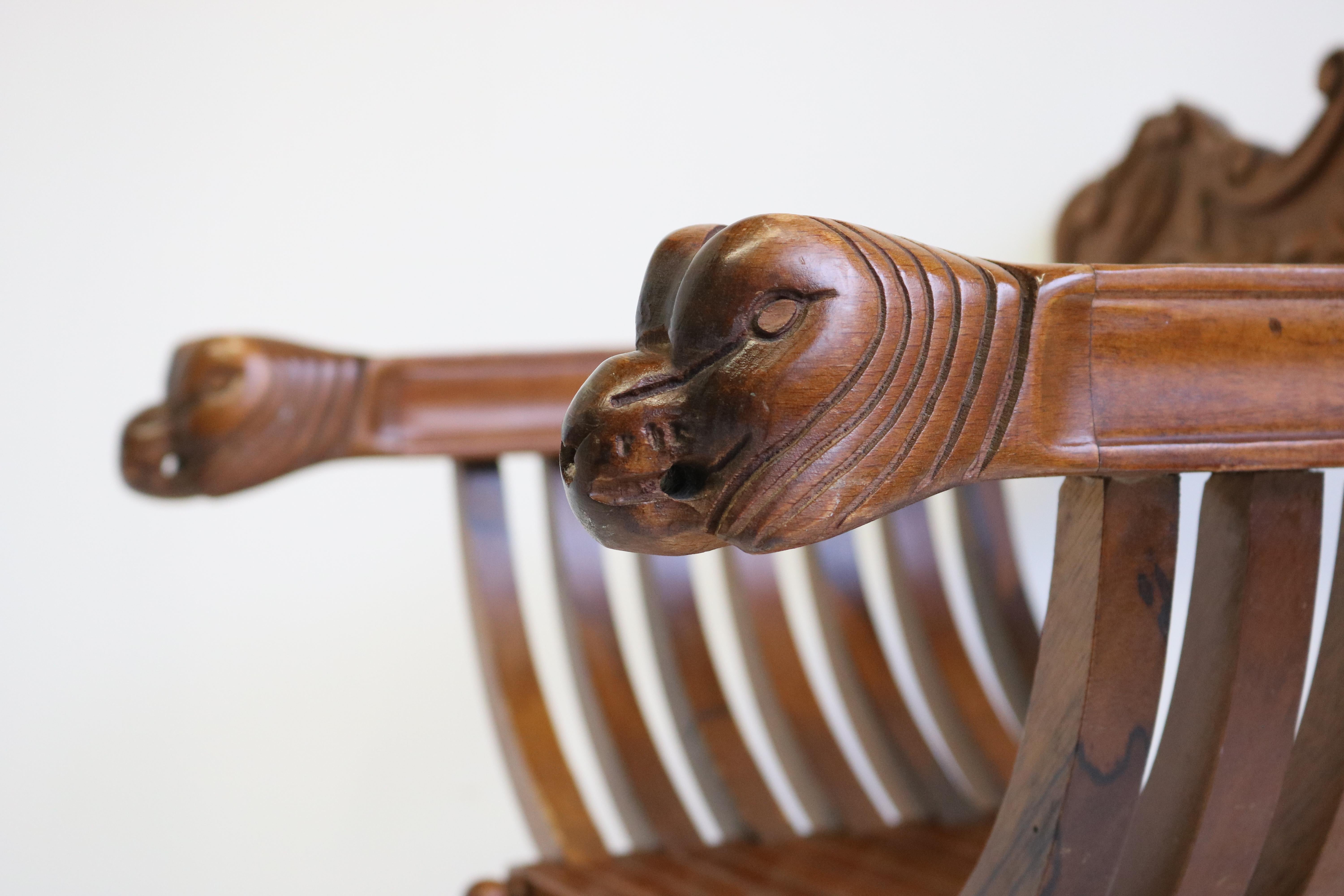 Impressive & fully original Florentine Renaissance Savonarola chair in carved walnut. Restored in our workshop and it looks simply stunning. 
Armrests ending with two amazing hand-carved lion heads. The lion heads where used to display the