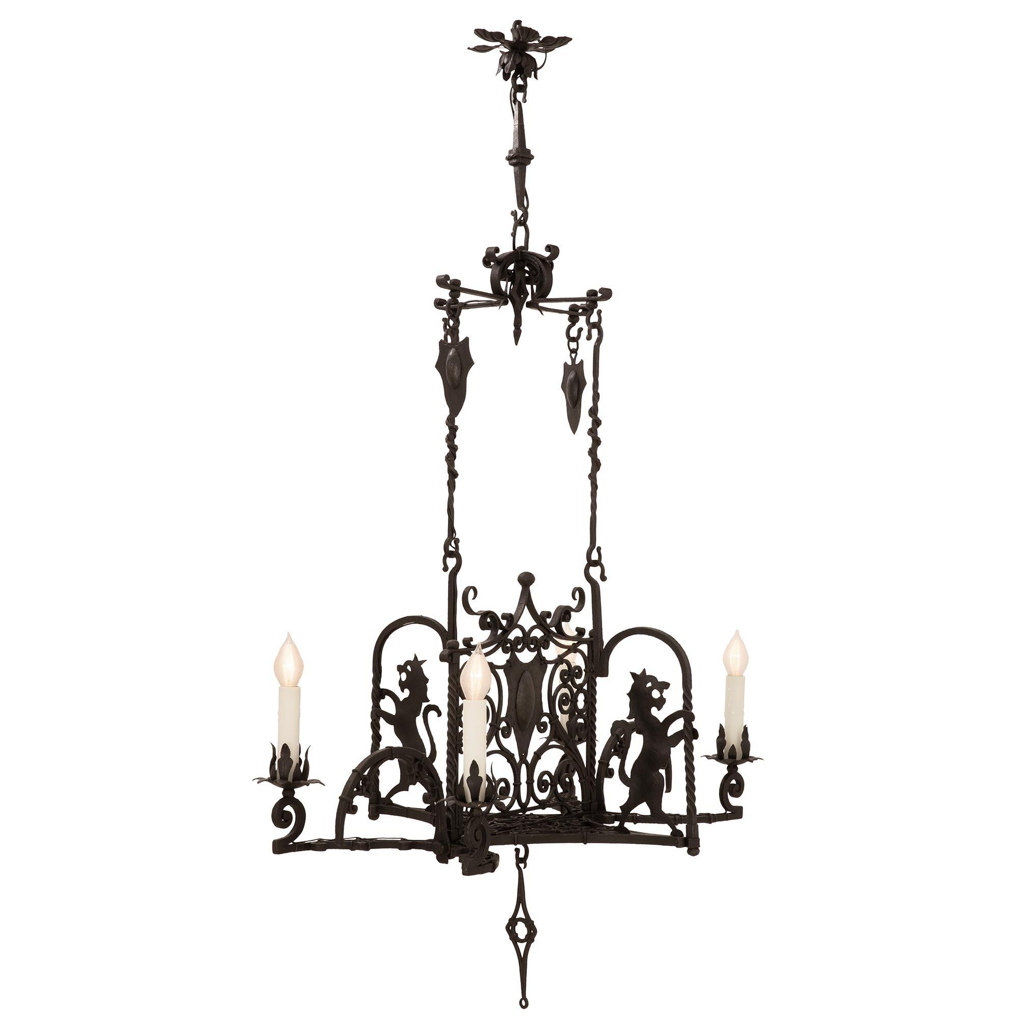 A beautiful and most unique Italian 19th century Renaissance St. wrought iron chandelier. The four arm chandelier is centered by an elegant curved diamond shaped pendant below the exceptional pierced bottom tier with the same shape when seen from