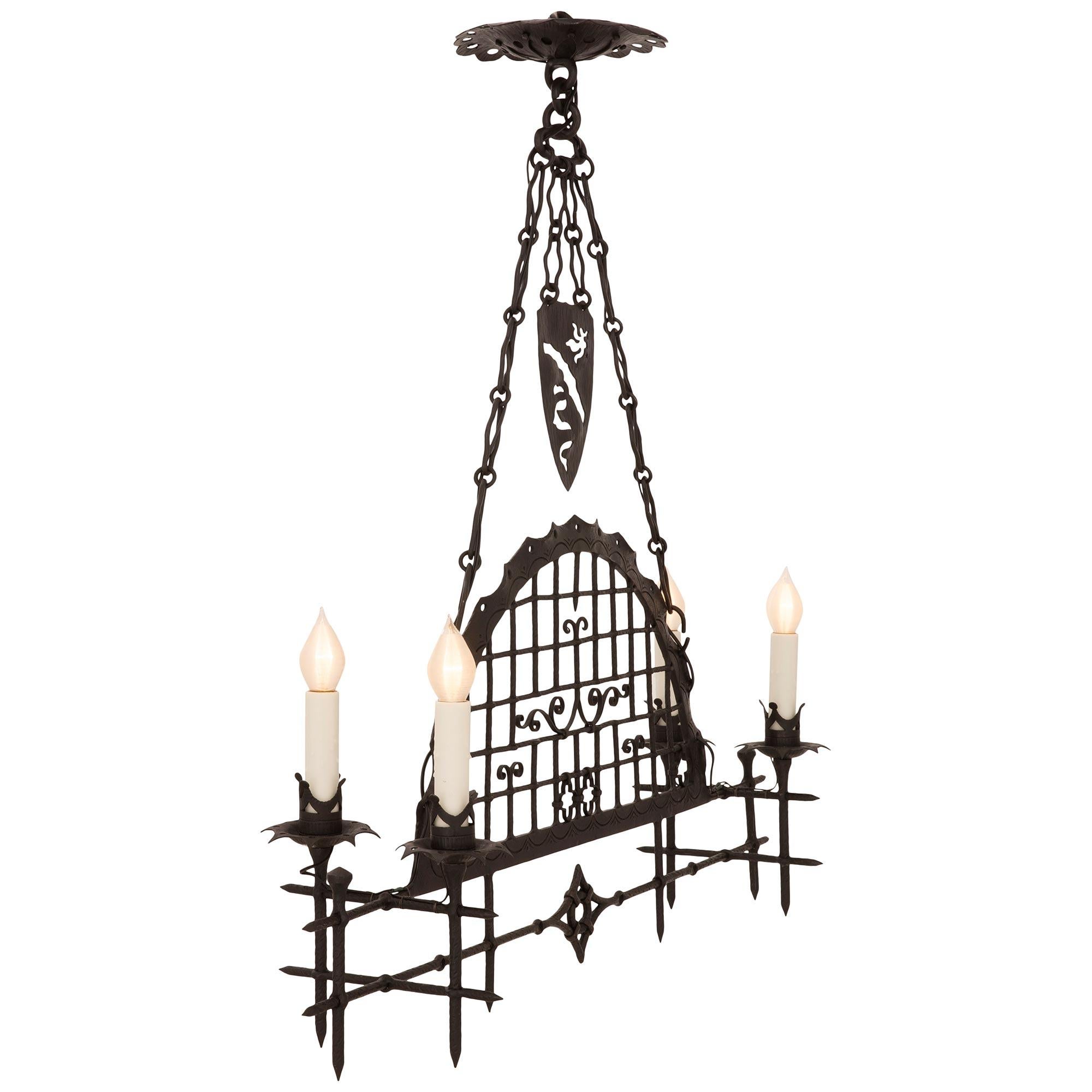 A striking and very unique Italian 19th century Renaissance st. wrought iron chandelier. The four arm chandelier displays eight impressive spikes with a beautiful pierced central curved diamond like and circular central reserve. The arched center