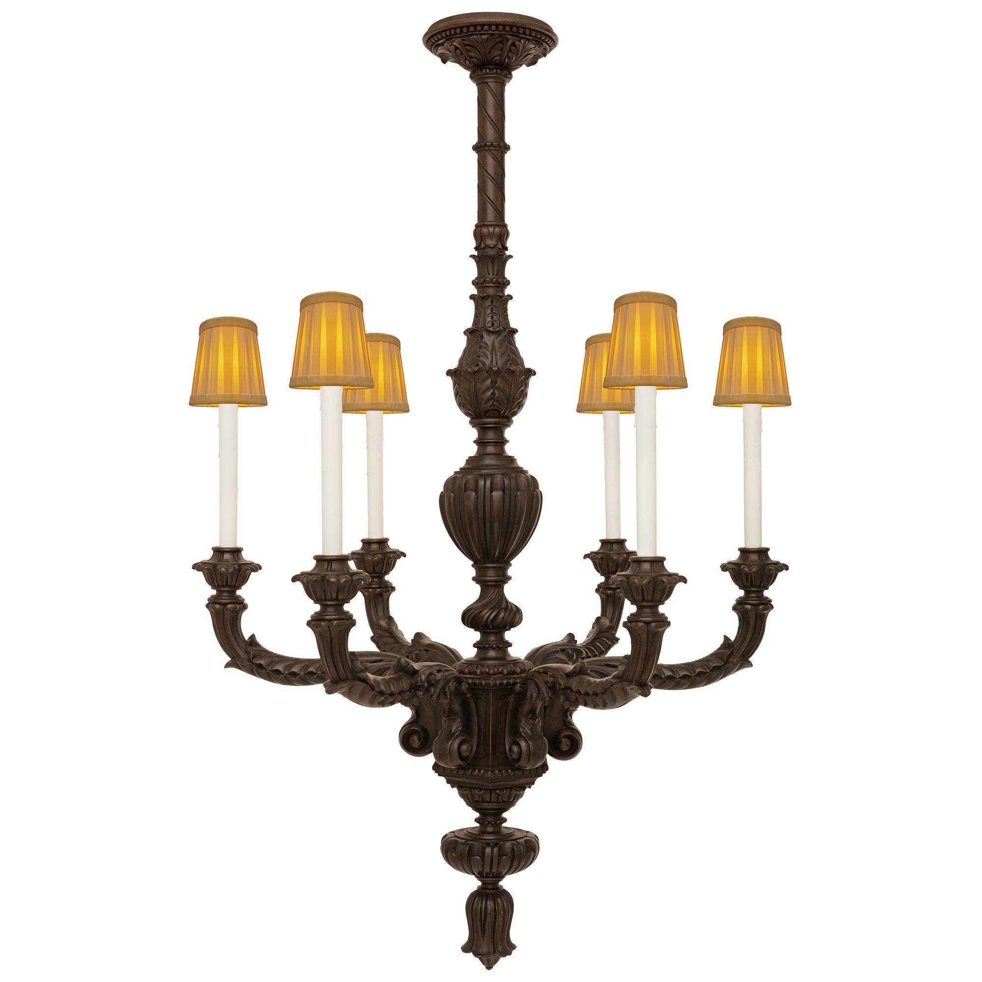 A handsome and wonderfully decorative Italian 19th century patinated Oak chandelier. This most unique chandelier is centered at the bottom by an inverted foliate finial below the six 'S' scrolled arms richly decorated with acanthus leaves and ending