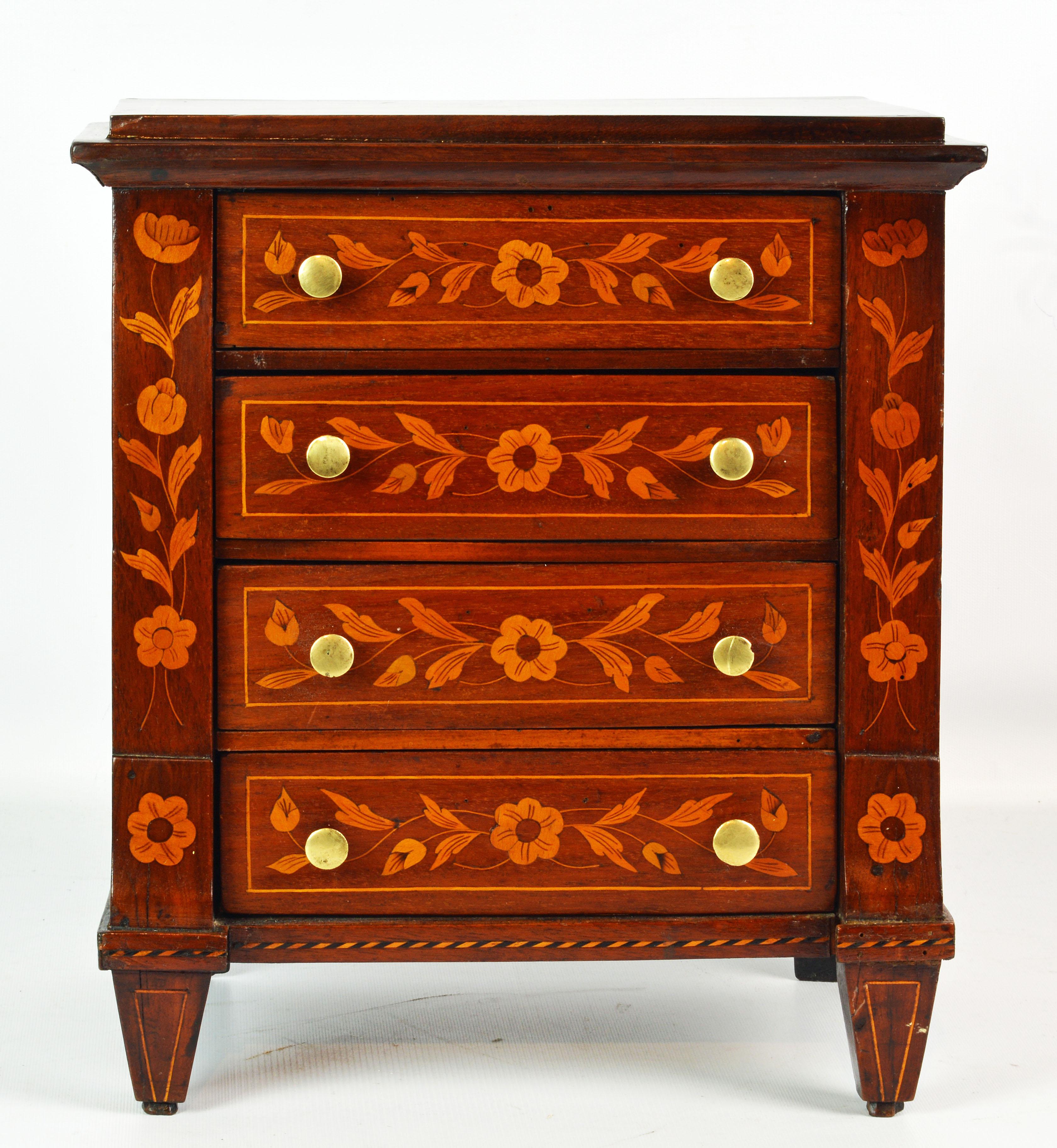 This adorable Italian 19th century miniature chest of drawers or jewelry chest features floral inlay on the top as well as the drawer front and the sides, all very detailed and in a pleasing color combination. Two of the drawers are lined with red