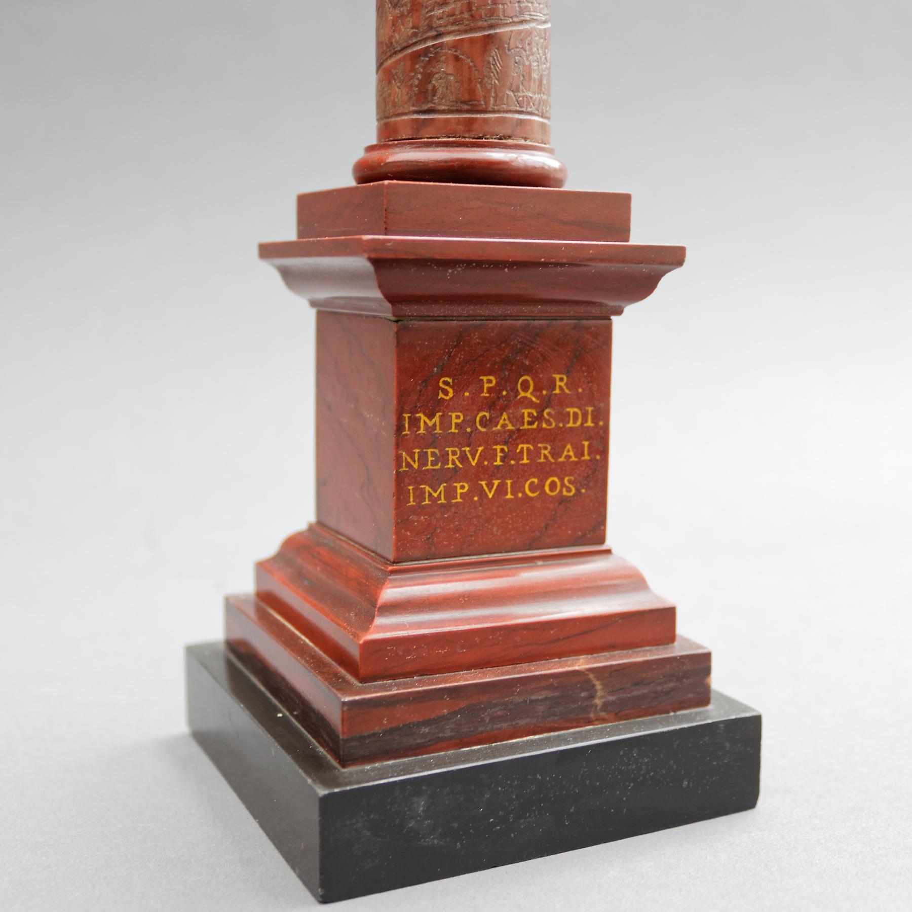 An Italian Grand Tour 19th century patinated bronze and Rosso antico marble model of Trajan's column. With the Emperor Trajan standing atop a column depicting the story of his vitorious wars. On a stepped square base inscribed with Latin: S.P.Q.R.