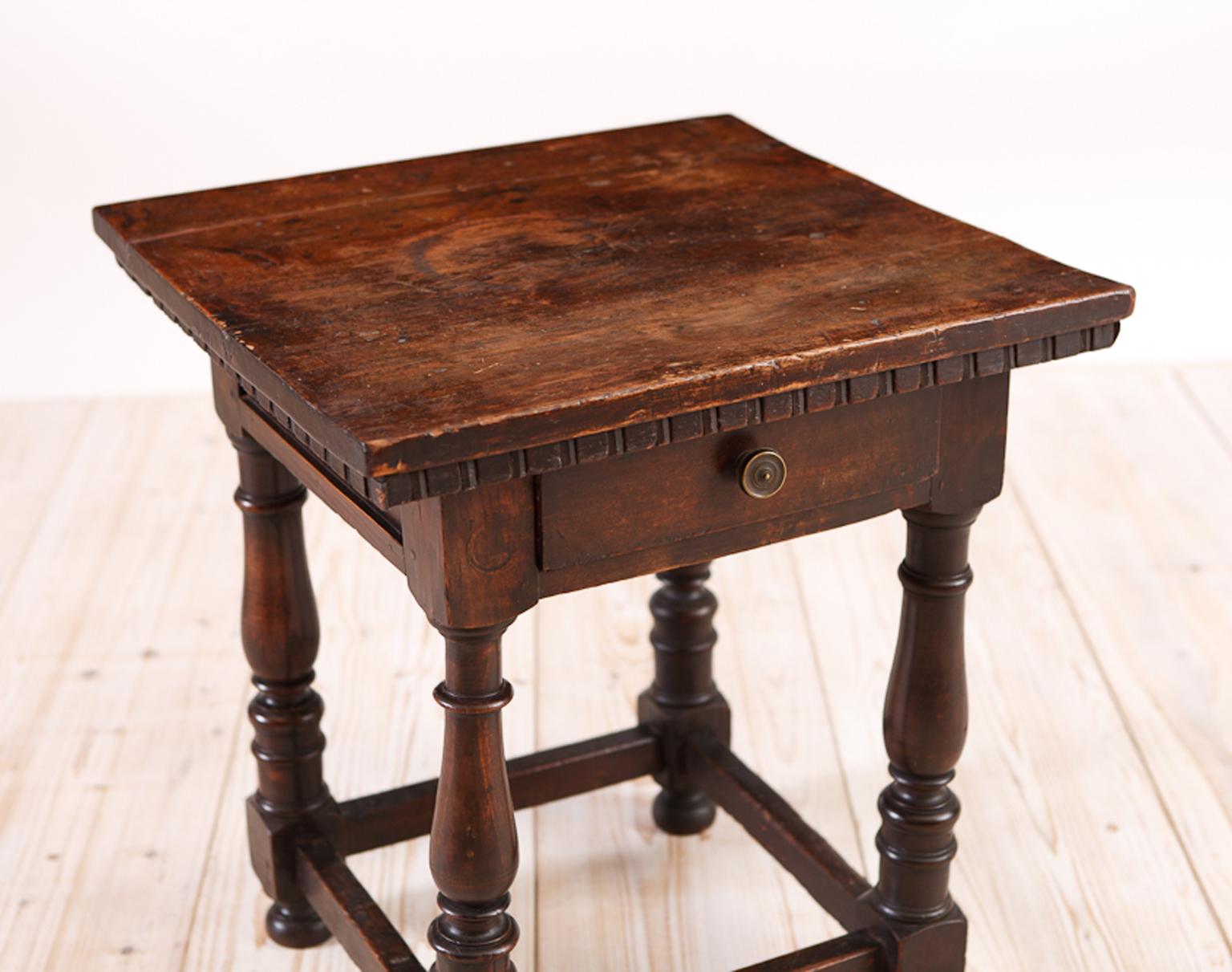 A small rustic hardwood table with vase-ring-and-cup turned legs on box stretcher with bun feet that are part of the leg turning.  All elements of the table appear to be original 19th century and possibly Italian in origin. Offers one