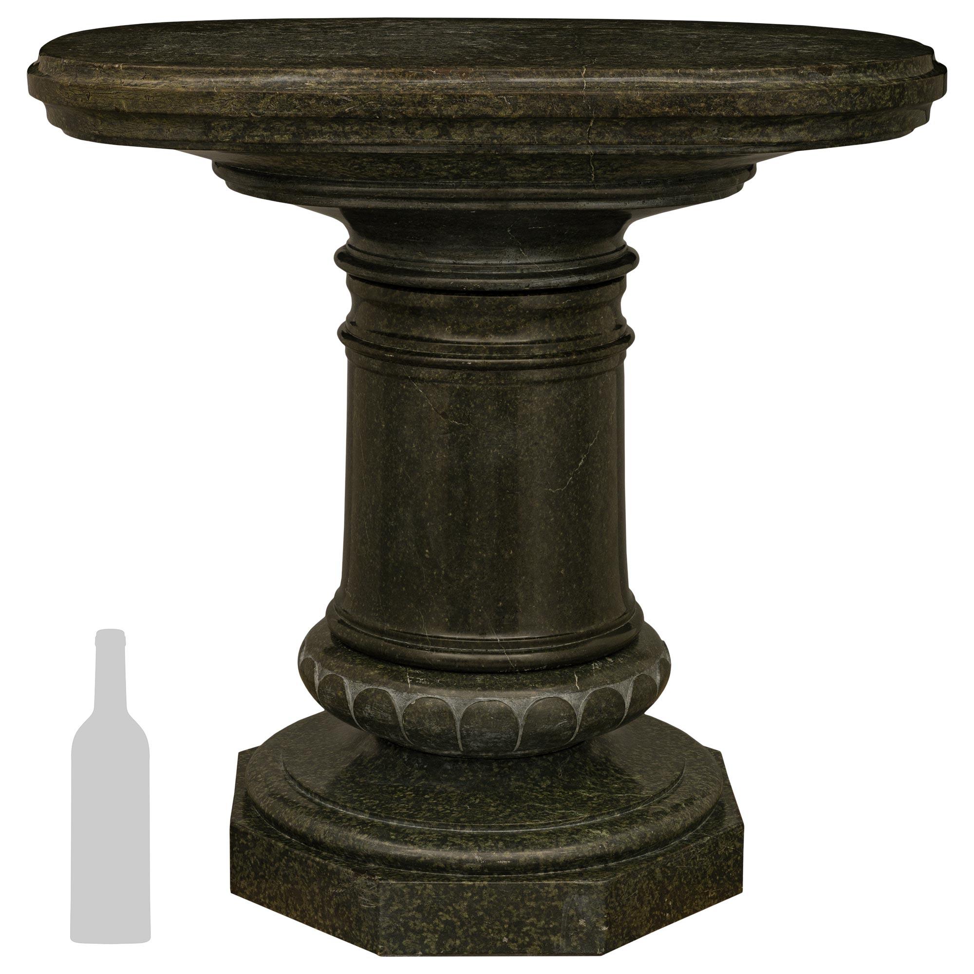 A very handsome and most impressive Italian 19th century Serpentine marble pedestal. This large scale pedestal is raised by an octagonal base with a socle shaped circular plinth above. The top of the socle is decorated with wonderful wrap around