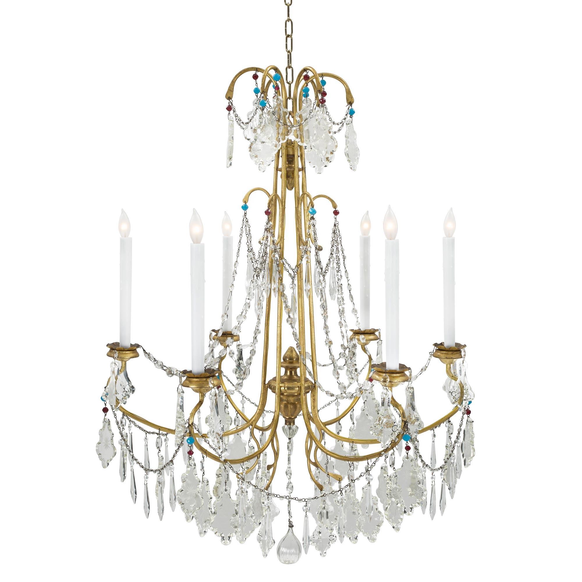 A most elegant and charming Italian 19th century six light gilt metal, giltwood and crystal Genovese chandelier. The chandelier is centered by a fine and wonderfully executed hand blown fig shaped pendant surrounded by a beautiful array of crystal