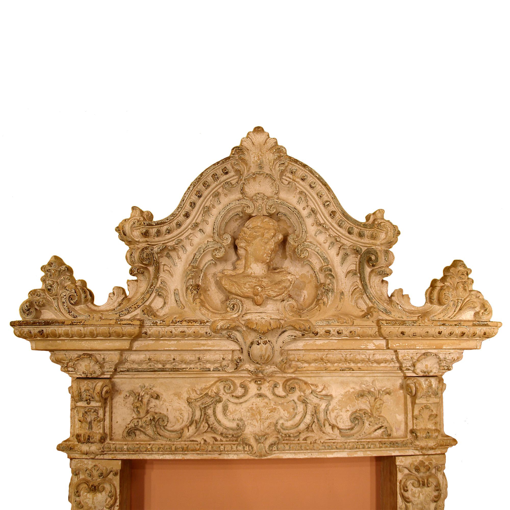 A rare Italian 19th century terra cotta fireplace mantel, from a Château in Sologne, France. The mantel is highly decorated by scrolled acanthus leaves, shells, flowers and central crests. Charming cherubs faces at the bottom. Impressive top crown