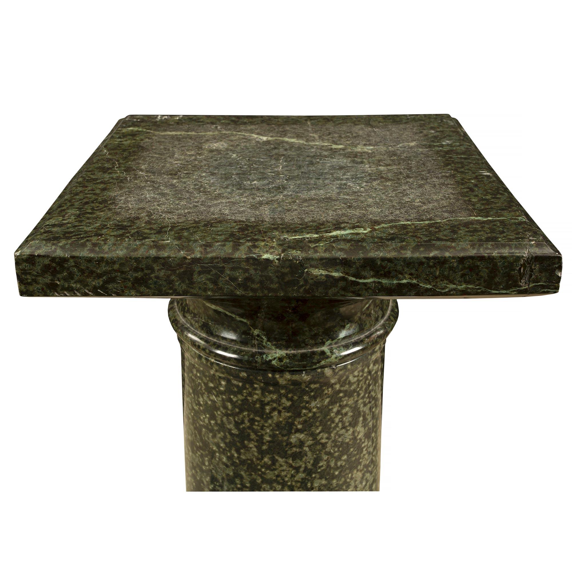 A fine Italian 19th century three piece green marble pedestal. The pedestal is raised by an octagon base with a mottled circular design above. The circular column has a carved design at the base. At the top is a square swivel shelf.