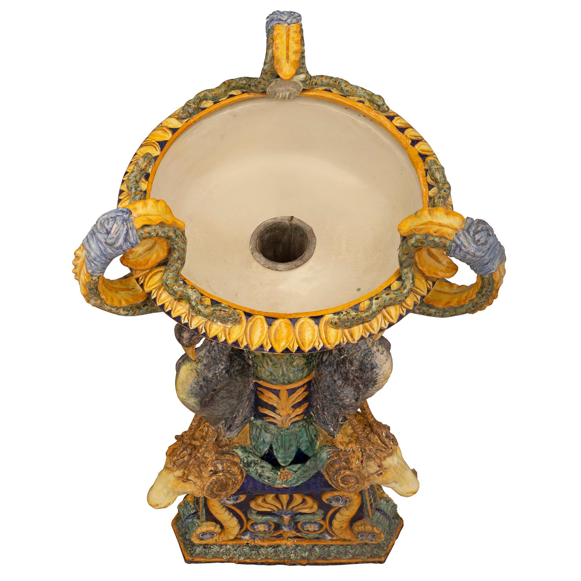 A sensational and rare Italian 19th century three-piece Majolica planter. The large-scale planter is raised by a triangular pedestal base with cut corners and decorated with a striking central palmette flanked by rich large scrolls. The central
