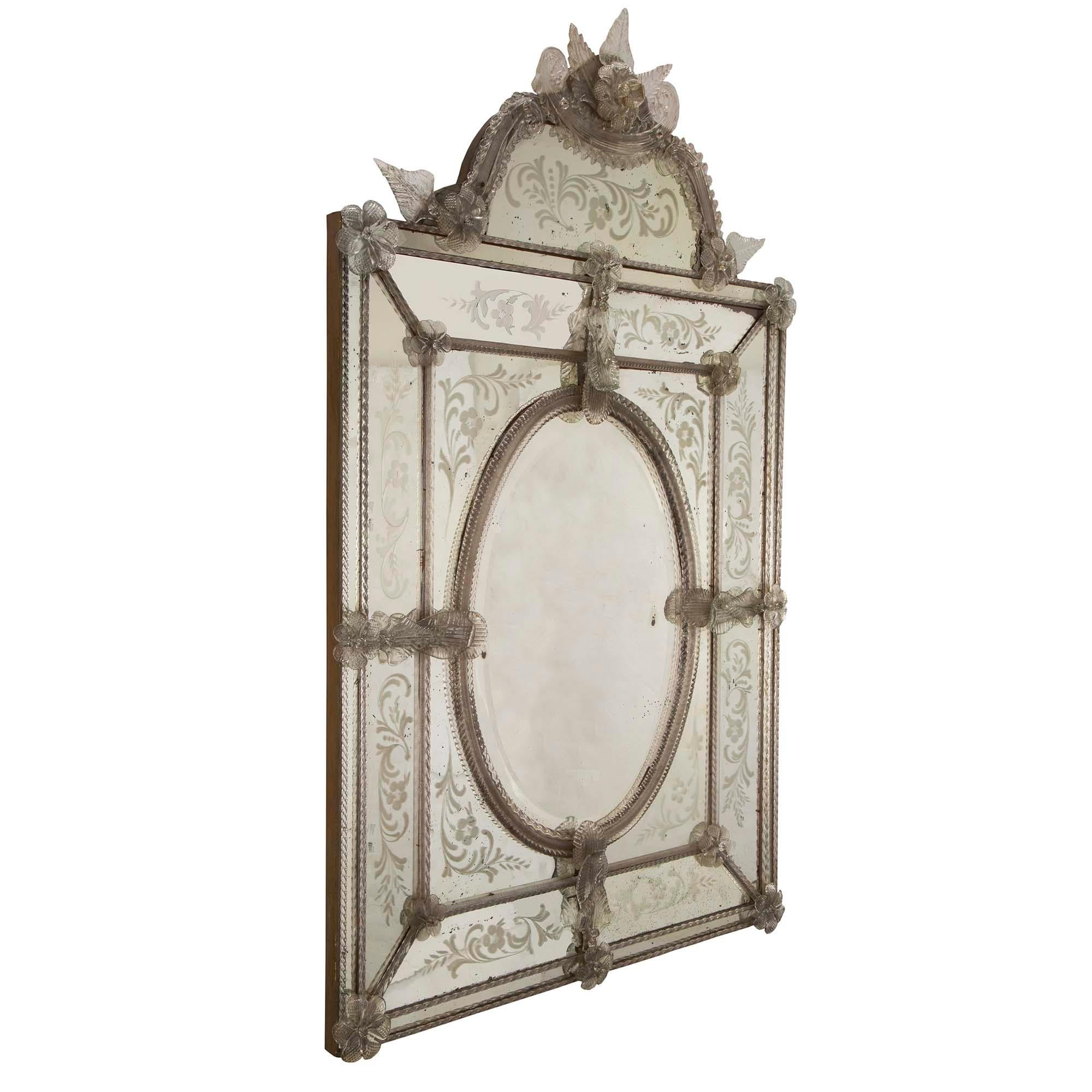 A stunning and high quality Italian 19th century Venetian and Murano glass triple framed mirror. The original central beveled mirror plate is framed within fabulous twisted Murano glass fillets with rich hand blown glass reserves. The outer original