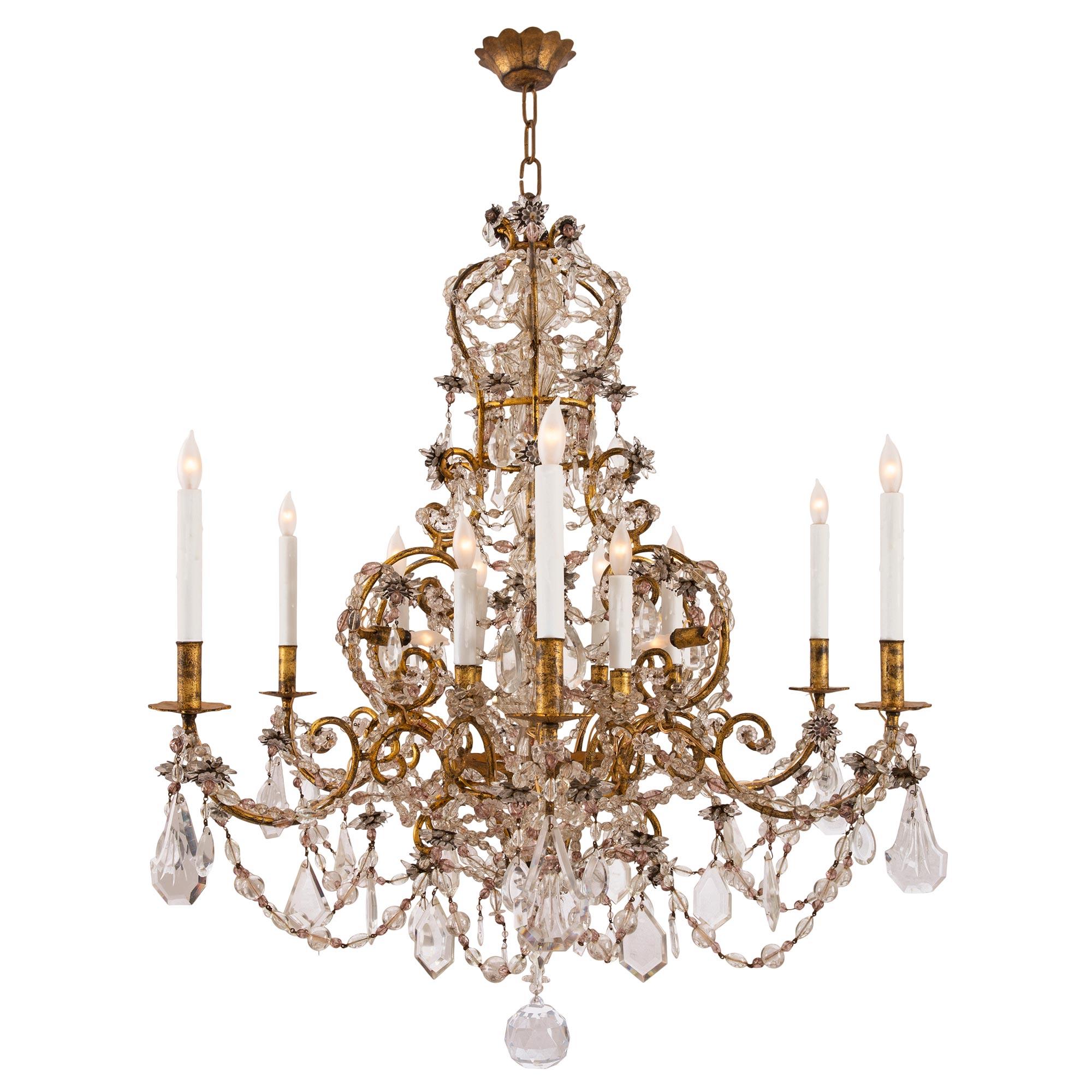 A beautiful and most decorative Italian 19th century Venetian st. gilt metal, crystal and glass chandelier. The twelve arm eighteen light chandelier is centered by an elegant solid cut crystal ball below a striking array of cut crystal pendants,