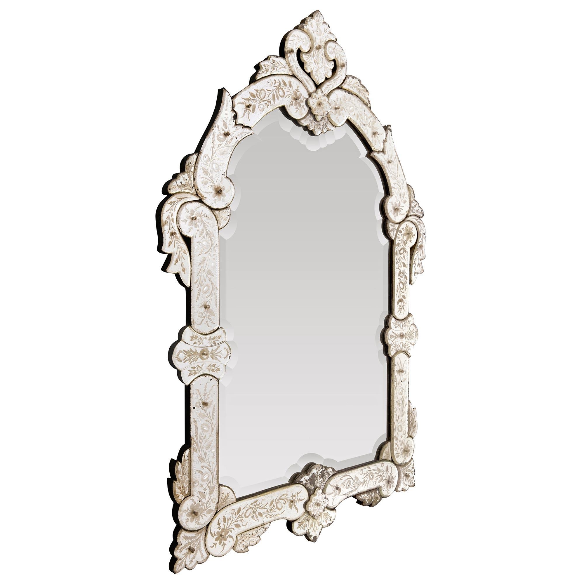 A stunning and extremely decorative Italian 19th century Venetian st. mirror. The mirror retains all of its beautiful original glass components throughout with the central mirror plate displaying an exceptional and wonderfully executed bevel
