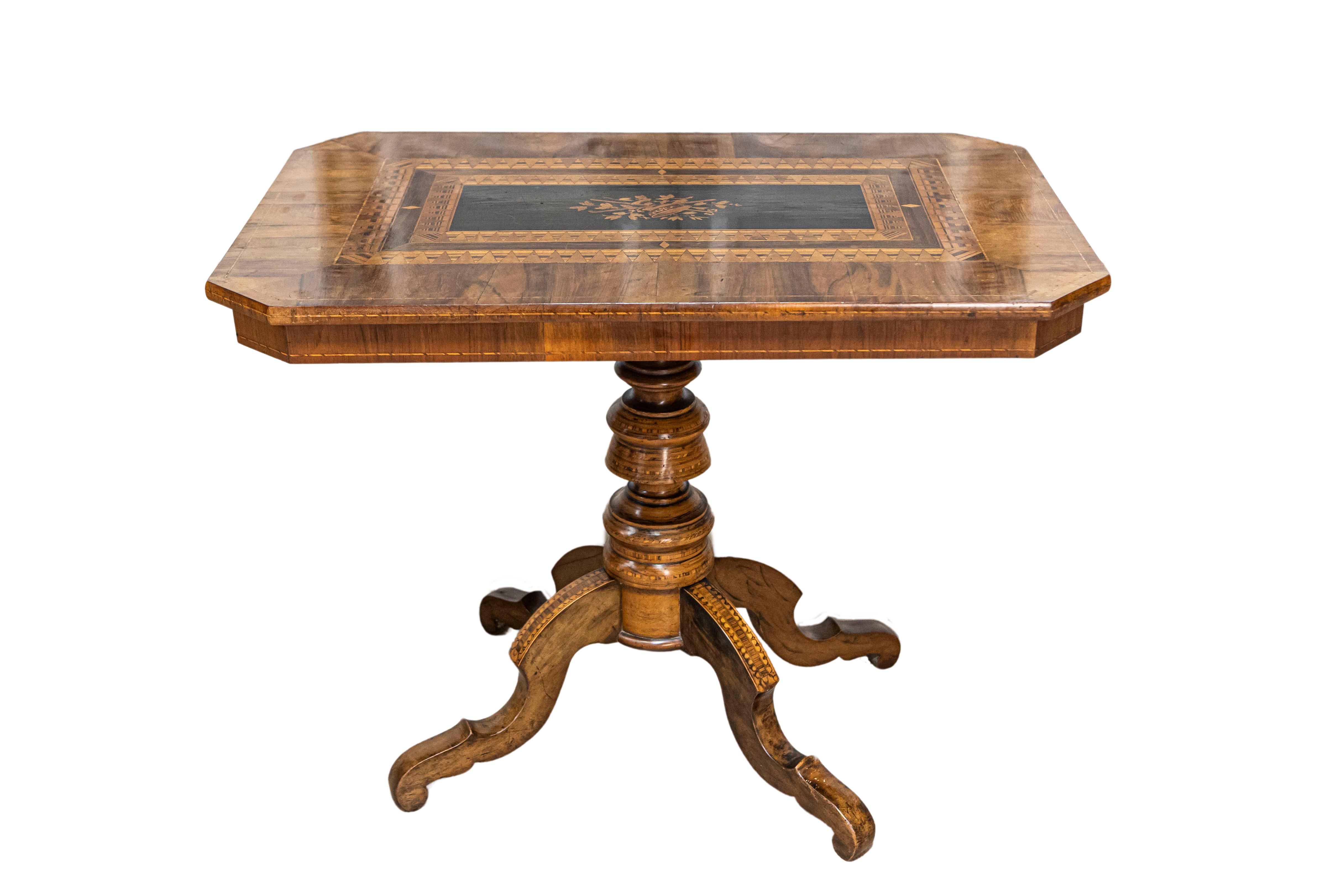 An Italian walnut and mahogany center table from the 19th century with floral marquetry and quadripod base. This exquisite 19th-century Italian center table is a masterpiece of craftsmanship, featuring a blend of walnut and mahogany woods. The