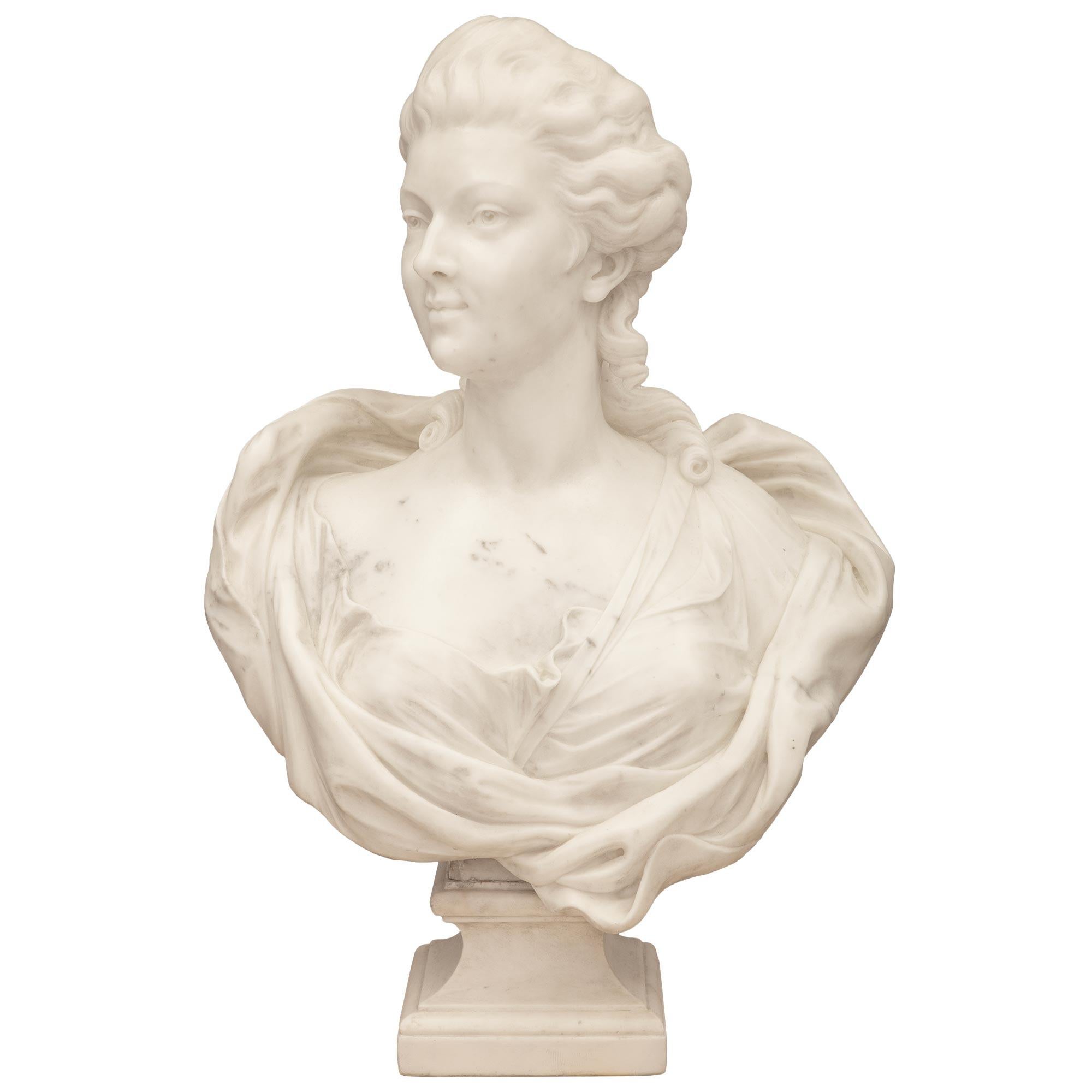 A striking and high quality Italian 19th century white Carrara marble bust of a beautiful young lady. The bust is raised by a square socle shaped pedestal support with a fine wrap around mottled border and elegantly curved sides. The wonderfully