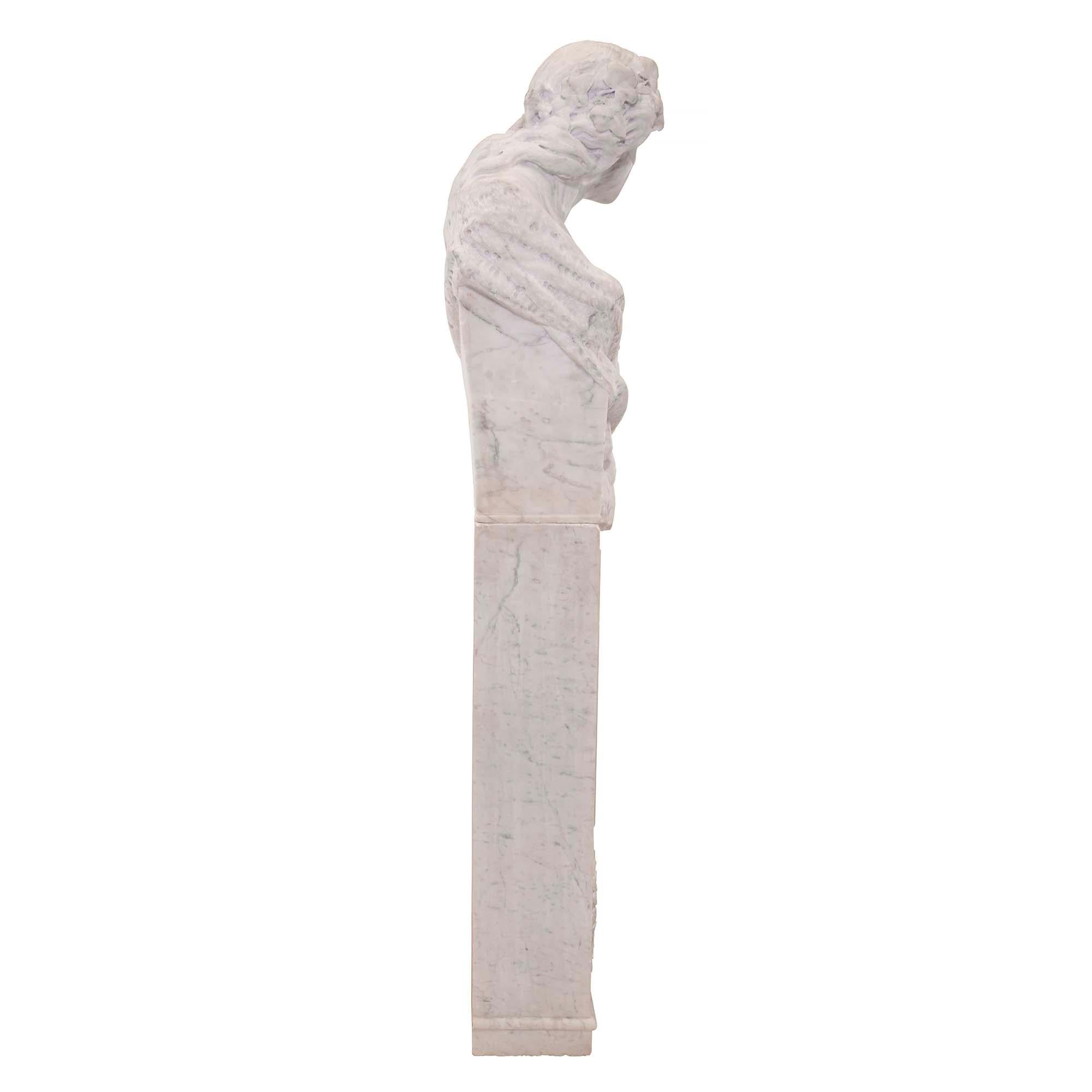 A very decorative Italian 19th century white Carrara marble freestanding statue of a Garden Maiden. The statue is raised by a rectangular marble pedestal with a richly carved floral wreath and a tied bow below a mottled raised panel. The upper