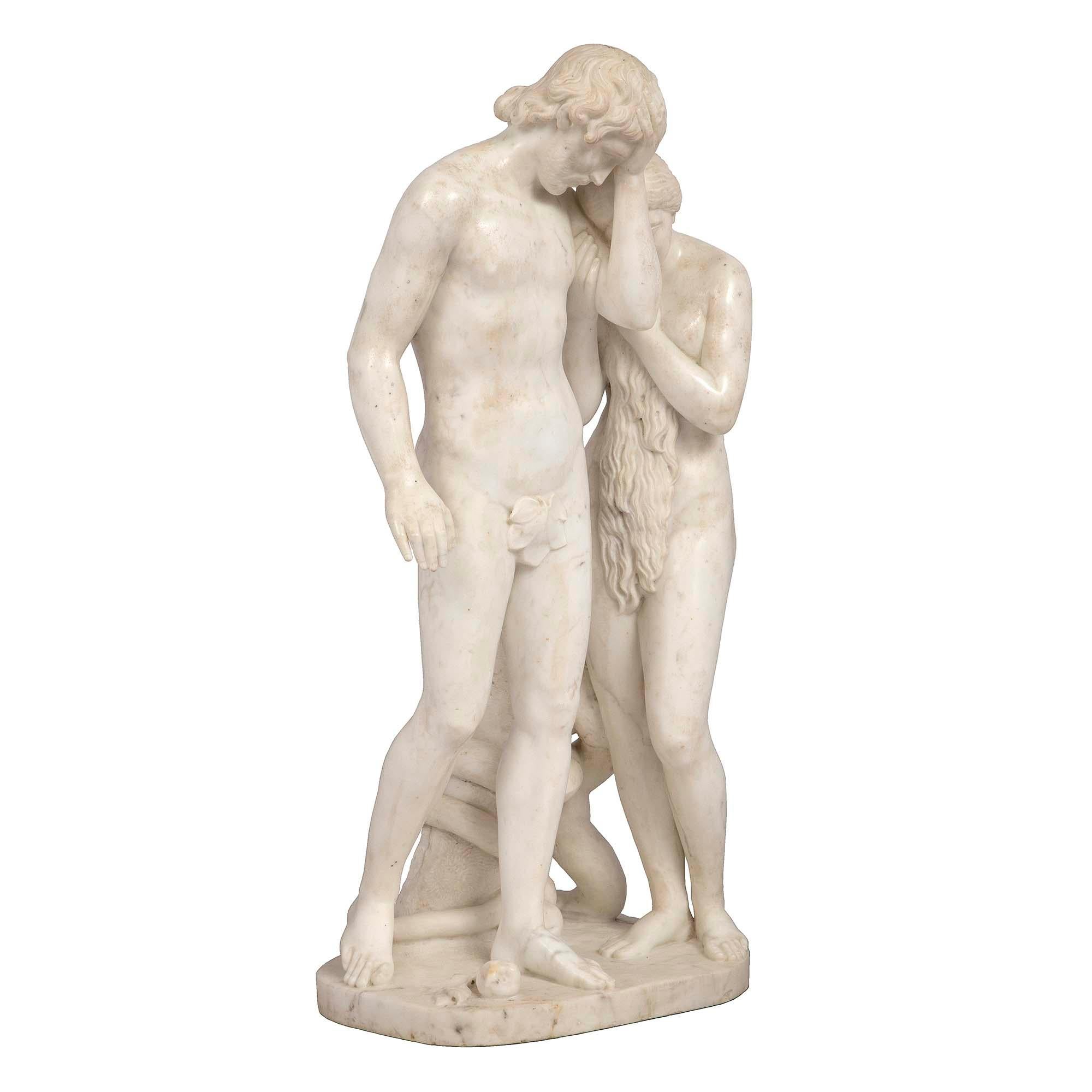 A beautiful Italian 19th century white Carrara marble sculpture of Adam and Eve. The sculpture is raised by a rock shaped base with a serpent wrapped around a tree trunk. Adam is depicted with an assuaged expression with an apple at his feet. Eve