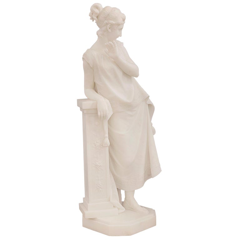 An exceptional Italian 19th century white Carrara marble statue of a beautiful maiden, signed F. Vichi. The statue is raised by a fine octagonal base with a decorative mottled border and wonderfully executed ground like design. The elegant and
