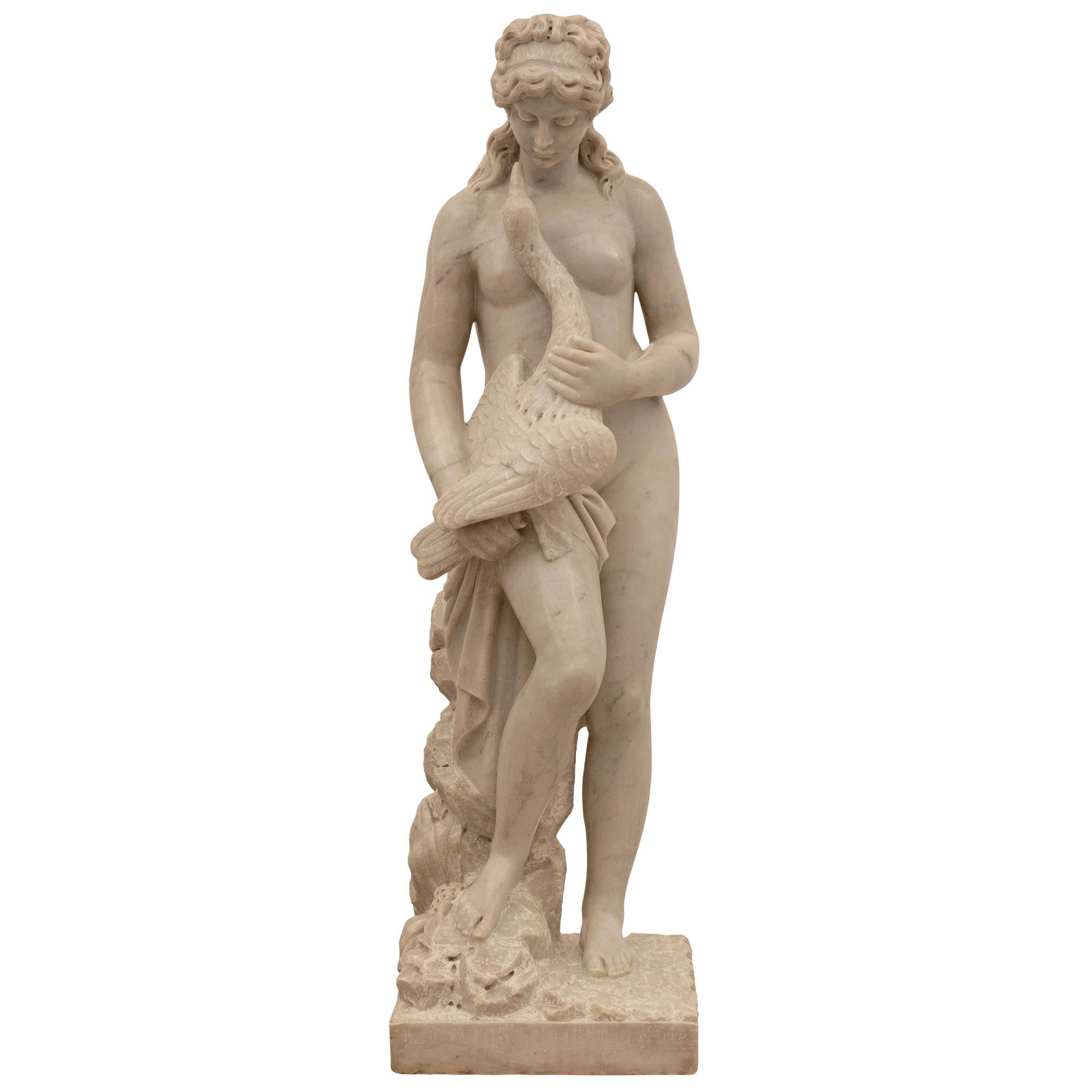 A beautiful and extremely high quality Italian 19th century white Carrara marble statue of Leda and the swan. The statue is raised by a square base with a superb ground like design with a most decorative rock formation leading up the back with