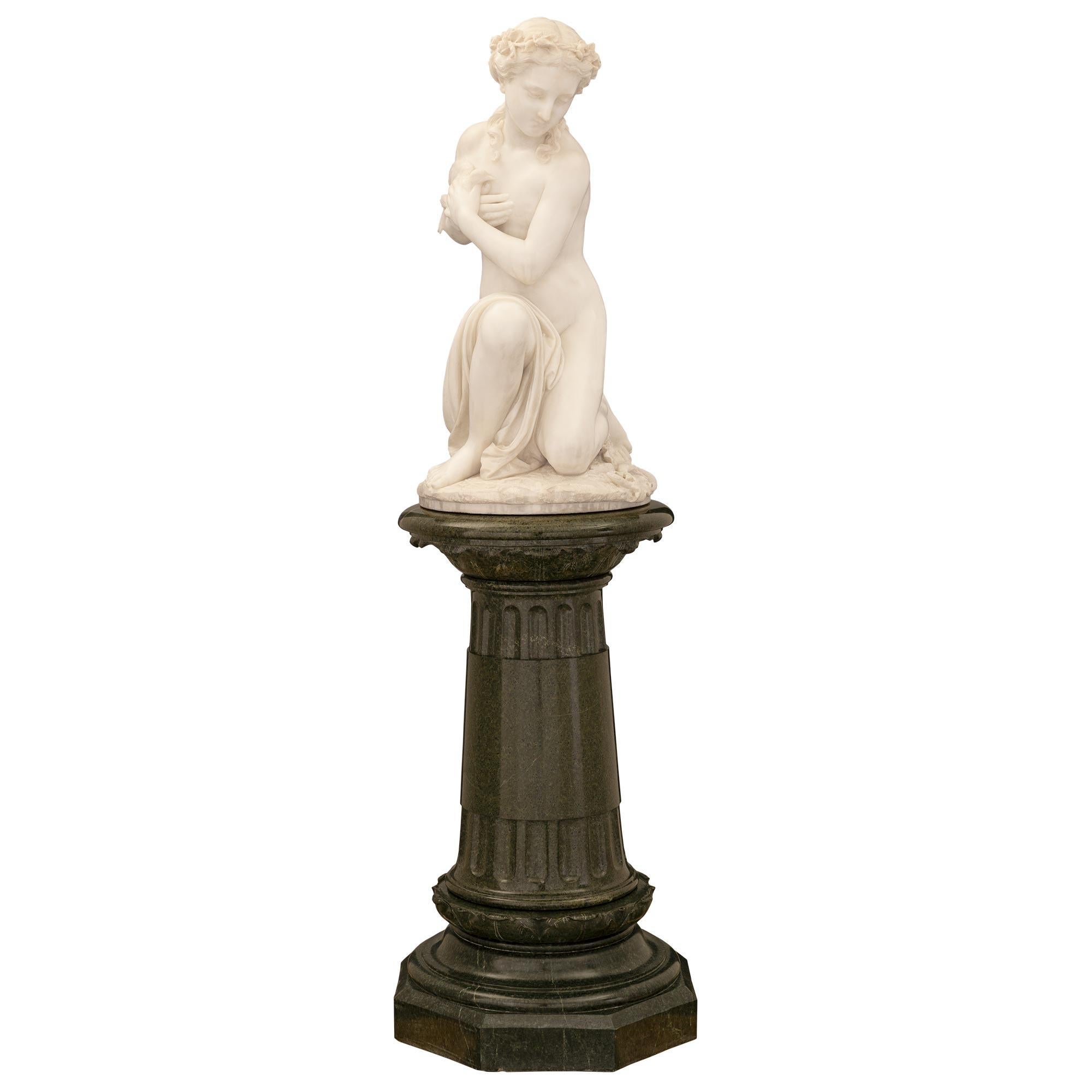 An exquisite and extremely high quality Italian 19th century white Carrara marble statue on its original Vert de Patricia marble pedestal signed Prof. R. Romanelli Firenze. The impressive pedestal displays a fine octagonal base below an elegant