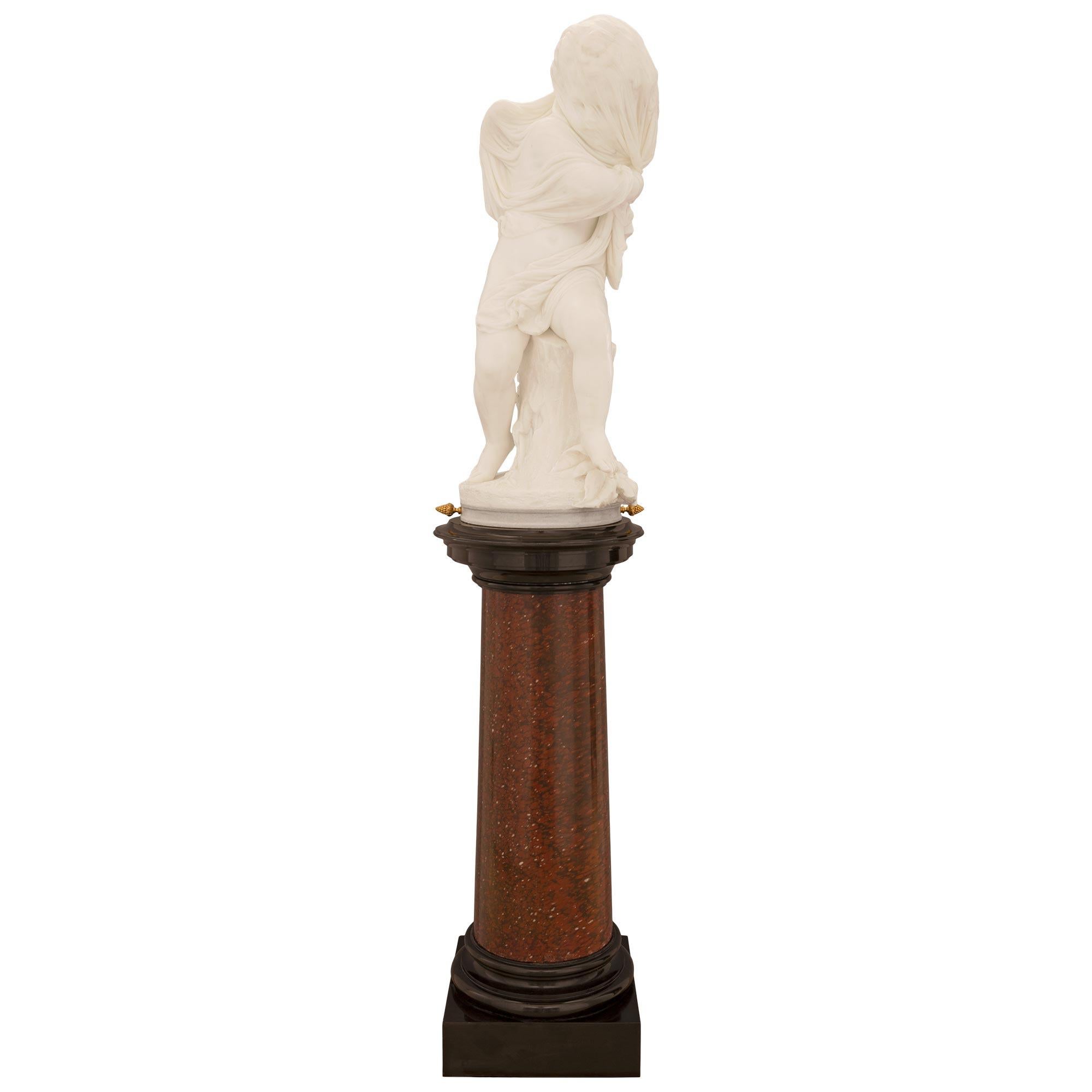 An exquisite and extremely high quality Italian 19th century white Carrara marble statue on its original Rouge Griotte and black Belgian marble pedestal named 