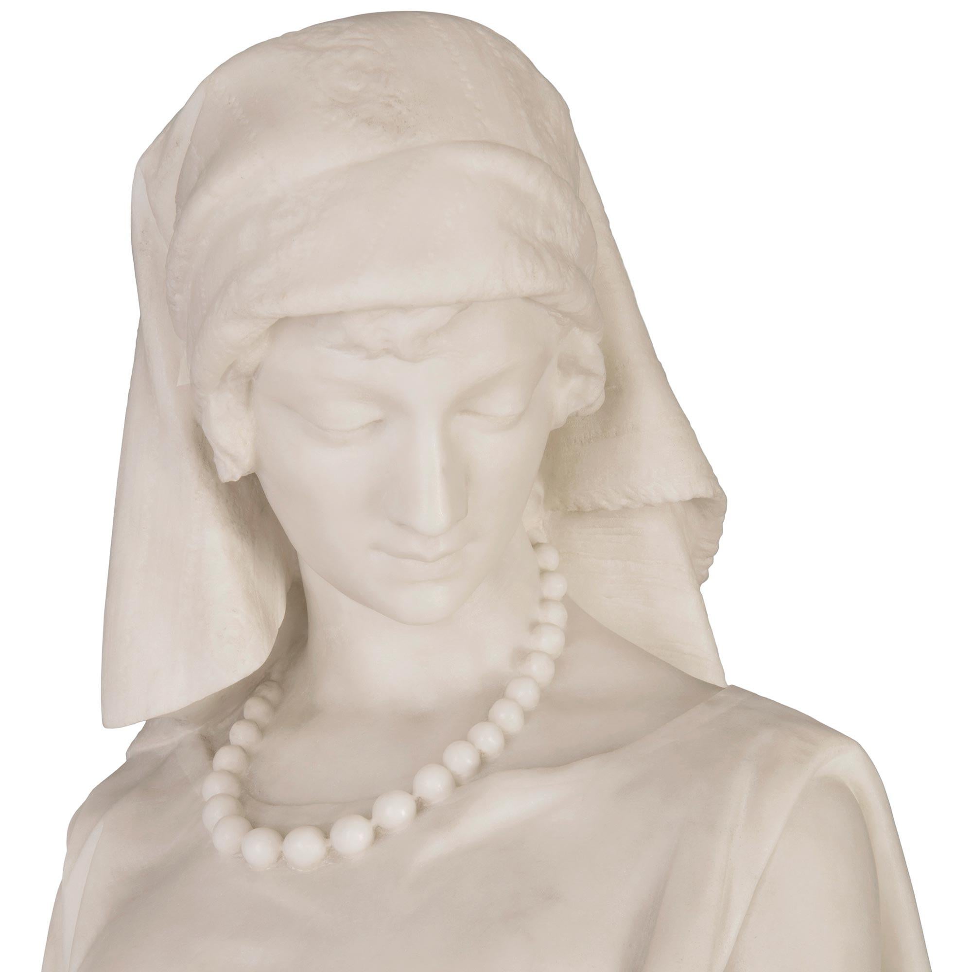 A stunning and large scale Italian 19th century white Carrara marble statue of Rachele and Lamb on it's original Vert de Patricia marble pedestal, signed F. Vichi. Firenze. The statue is raised by a its original pedestal with an octagonal base and