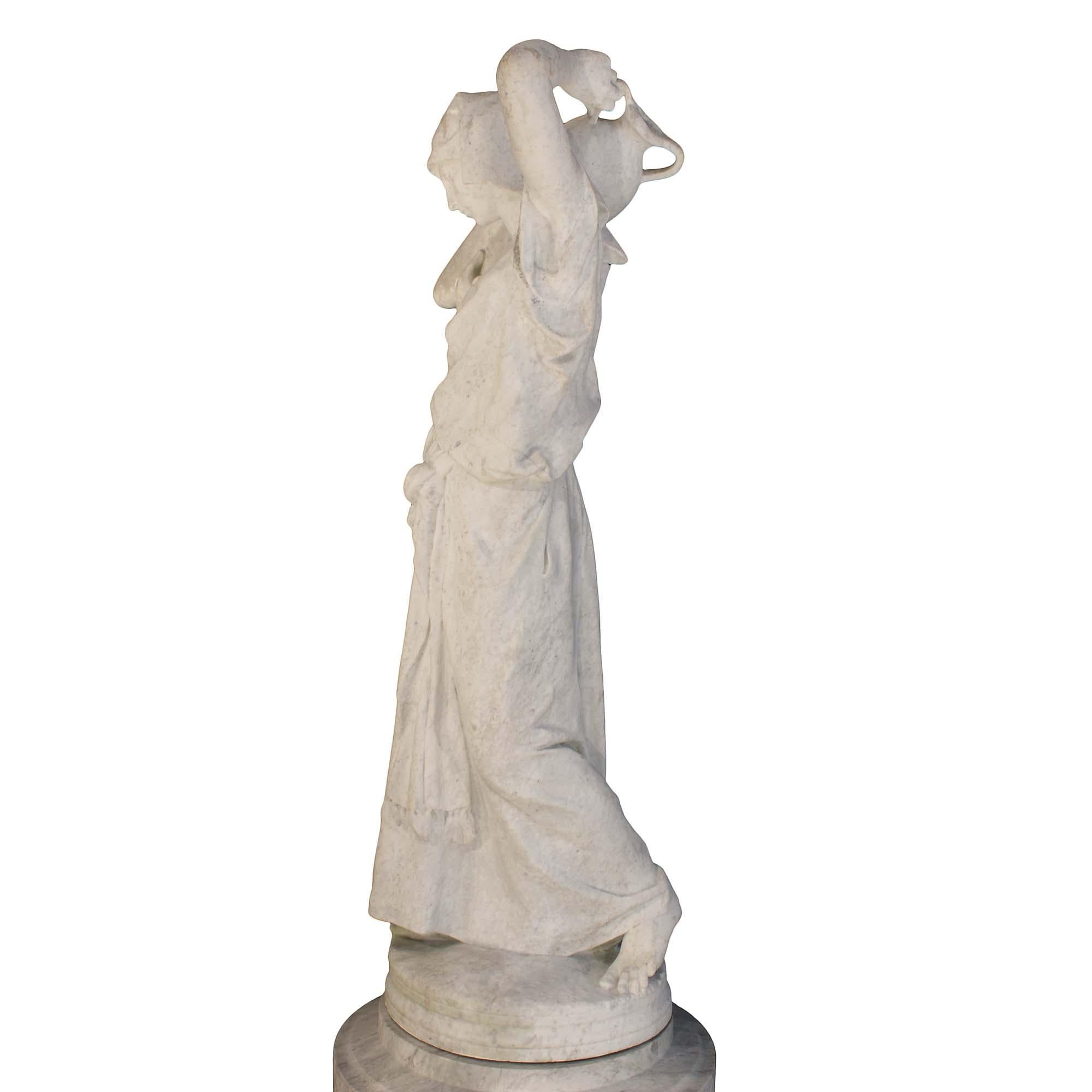 A very impressive and grand scale Italian mid 19th century white Carrara marble statue on a Gris St. Anne pedestal, signed Lazzarini. The statue is of a maiden in classical drape, with bare feet, carrying a large wine urn on her shoulder. The