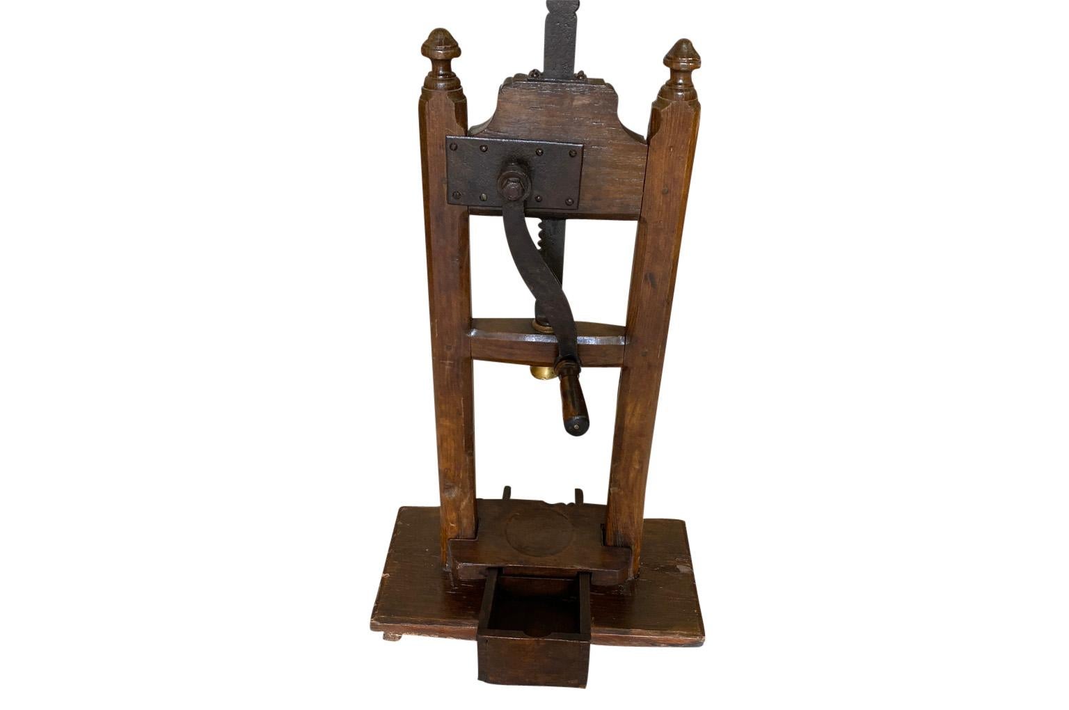 A charming 19th century wine bottle corking machine from the Tuscany region of Italy in wood and iron. A perfect accessory for any wine cellar of kitchen.