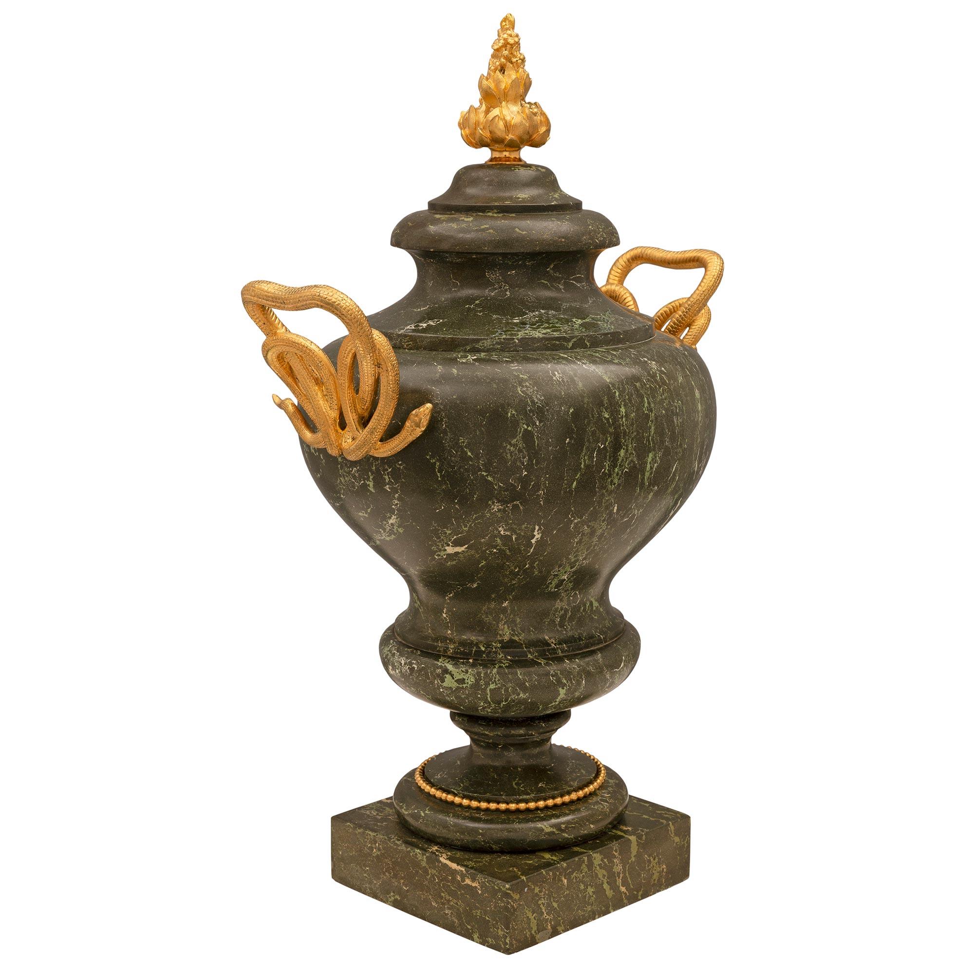 An impressive Italian 19th century Neo-Classical st. Scagliola and ormolu urn. The urn is raised by a square base below the mottled socle shaped pedestal support decorated with a fine beaded wrap around ormolu band. The elegantly shaped scagliola