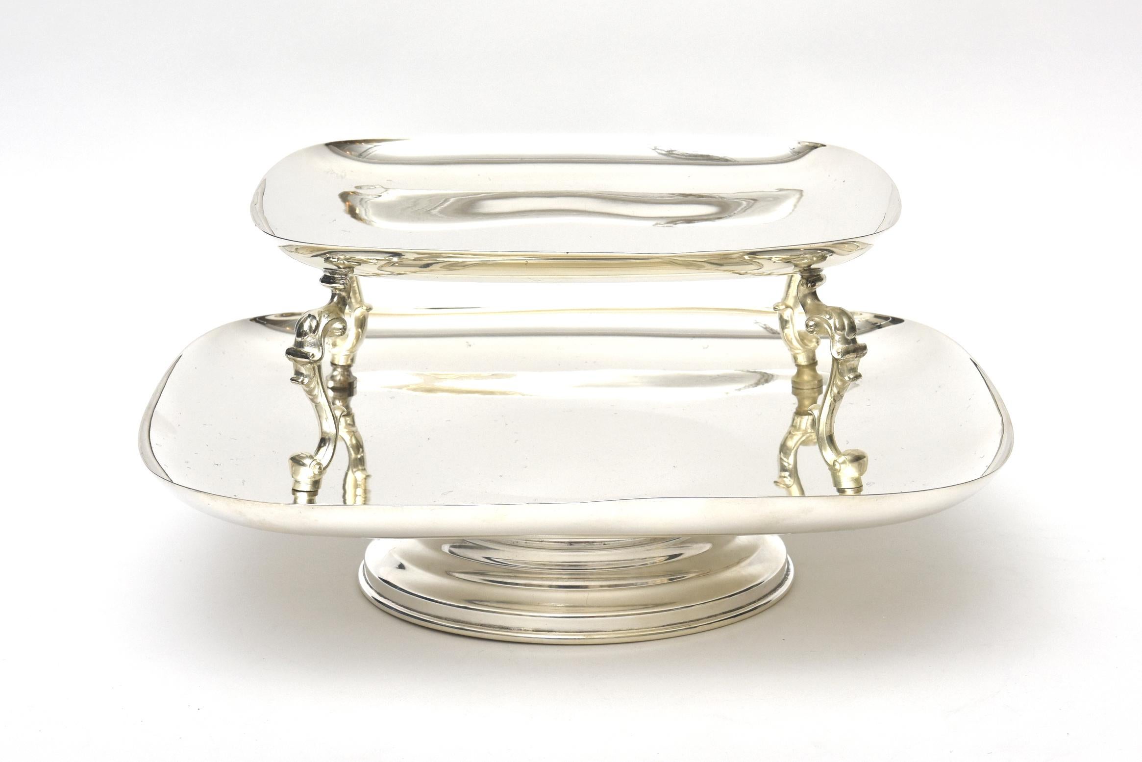 This large and modern looking 2-tiered serving caddy or serving piece swivels. The weight is good and solid. It is 7 inches to the top and between the two trays it is 4