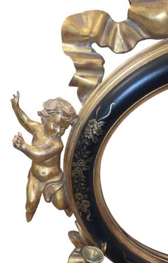 Italian 20th C. Rococo Style Ebonized & Giltwood Mirror w/ Putti & Candle Arms