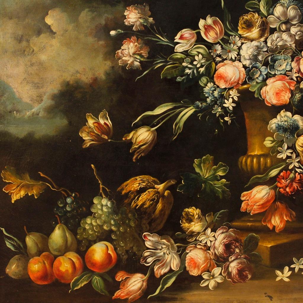 Great Italian painting from 20th century. Oil painting on canvas depicting still life with flowers and fruits of excellent pictorial quality in 17th century style. Carved and gilded wooden frame (bronze color) of beautiful decoration. Framework in