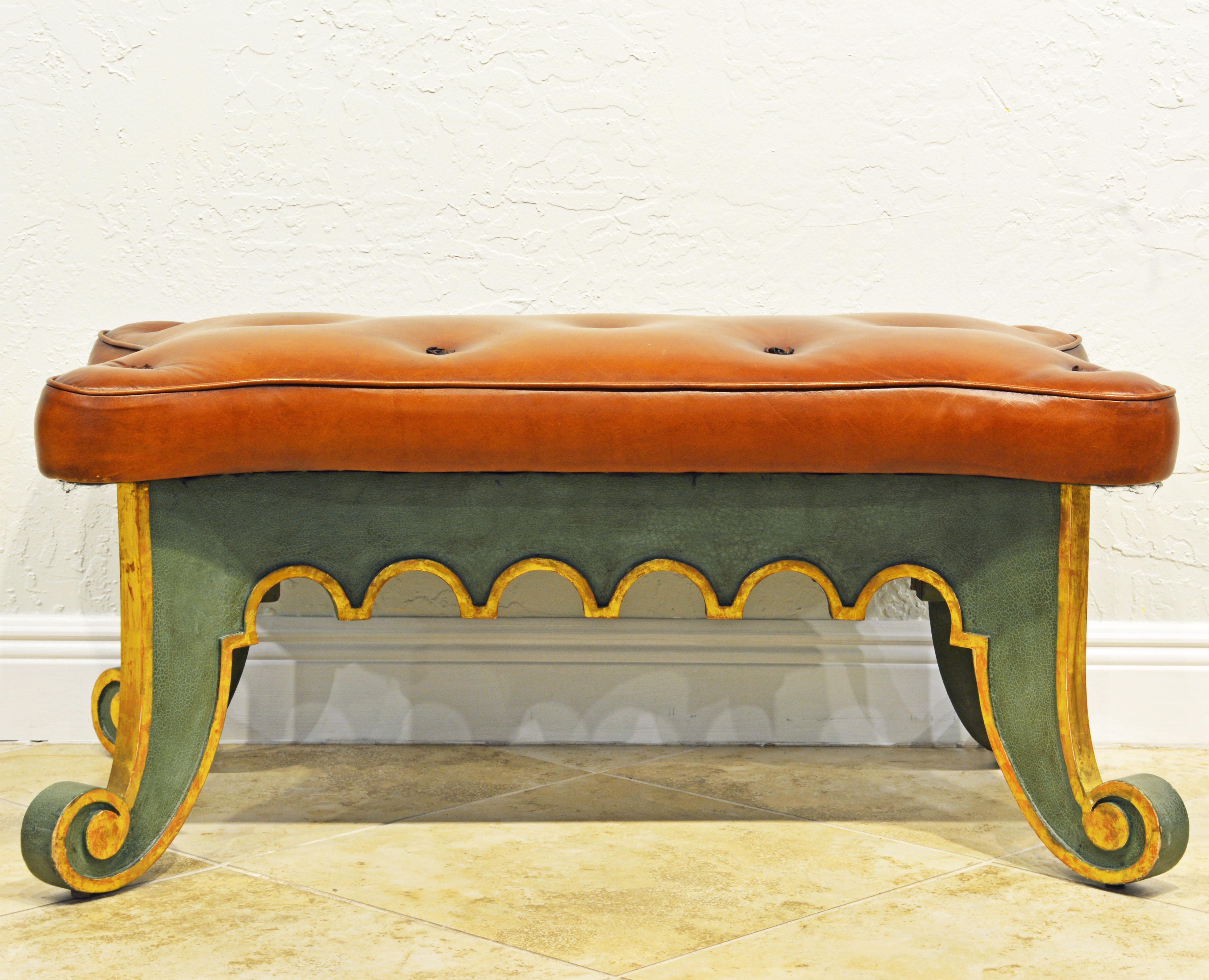 This Italian Venetian style bench features a beautiful tan tufted leather cover on comfortable upholstery set on a antique green painted frame with gilt trimmings on the carved arches and the elegantly scrolled legs and feet.