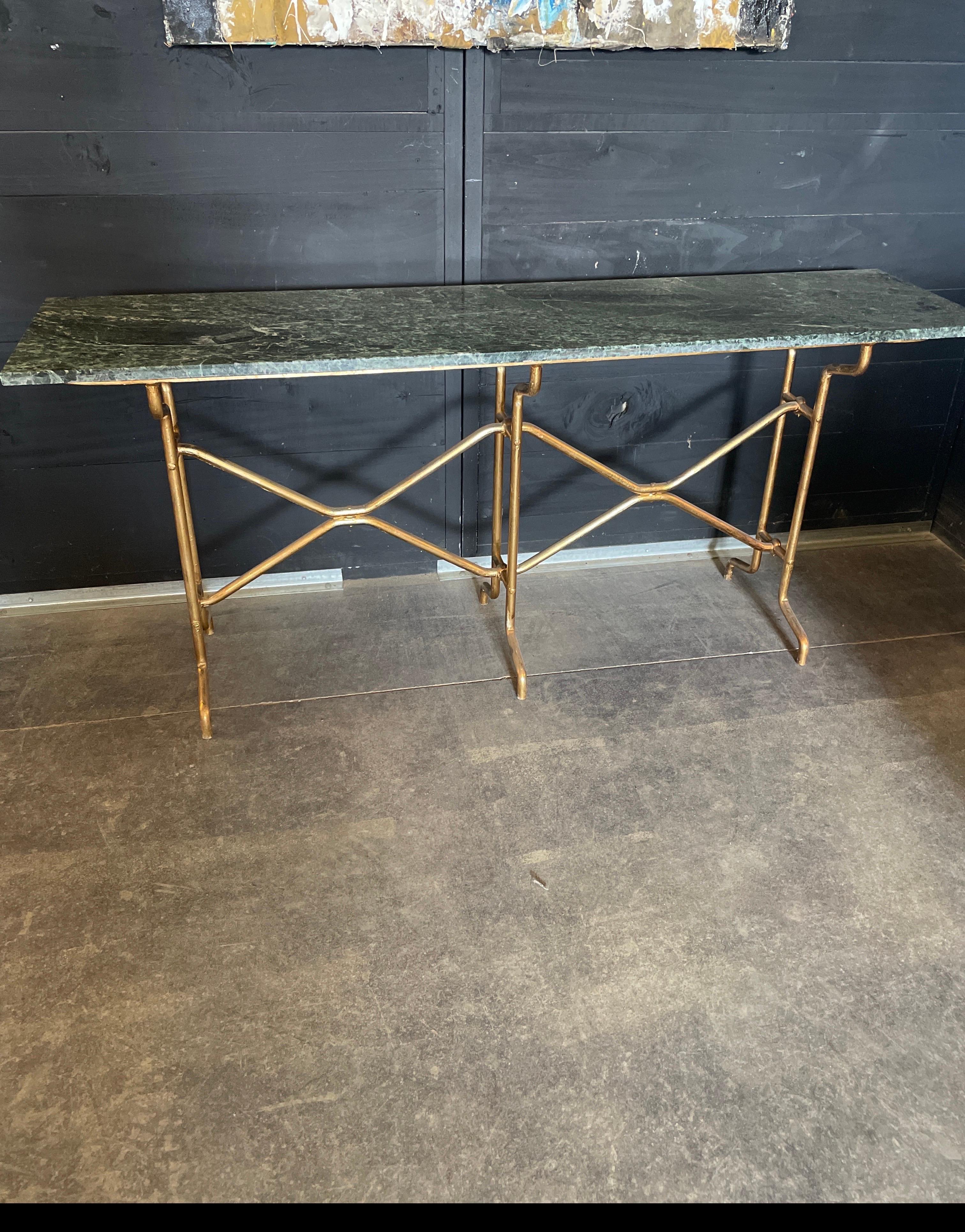 This Italian console from the creation of Giovanni Banci is beautifully made with hammered gold thick iron. The green marble top is in excellent condition as well for this vintage 1980 console.
It measures 67 wide x 15.5 deep x 29.1/8 tall