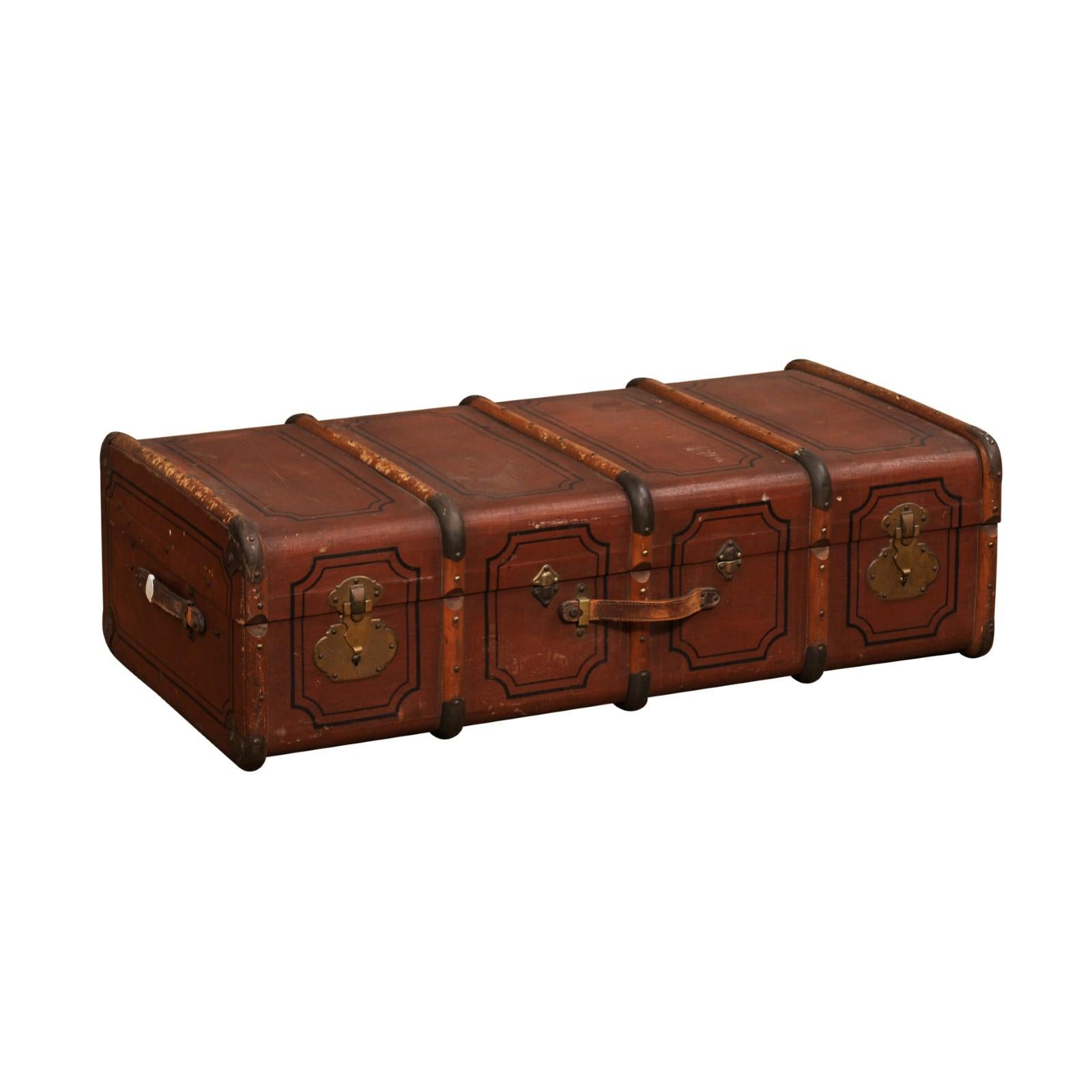 An Italian leather and wood travel trunk from the 20th century with lined interior, removable compartment, brass accents and great rustic character. Created in Italy during the 20th century, this leather and wood travel trunk will make for a