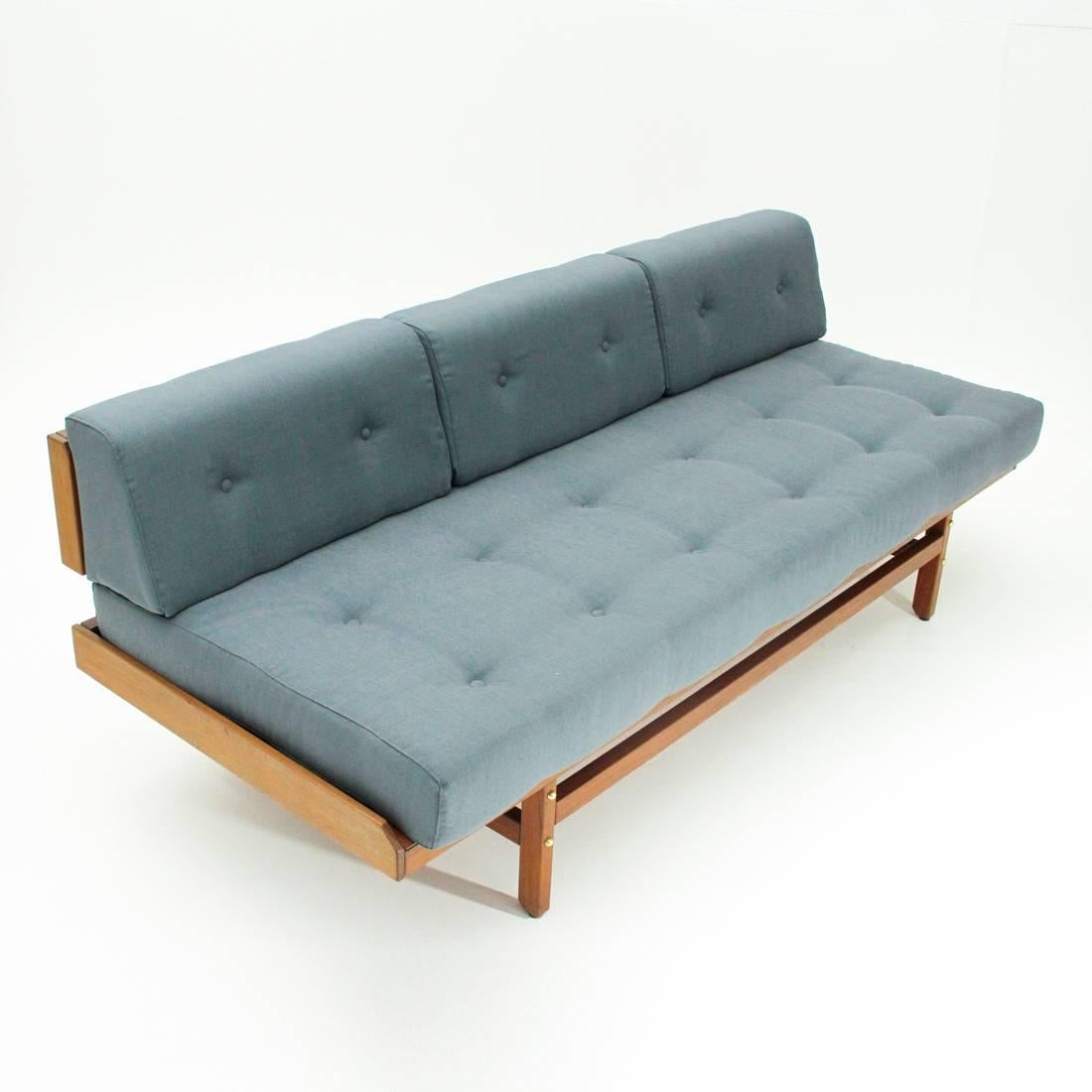 Sofa designed on a private commission by Umberto Brandigi for Poltronova.
Wooden structure.
Seat formed by a padded cushion and lined with new fabric and stitched with buttons.
Backrest formed by three padded cushions and lined with new