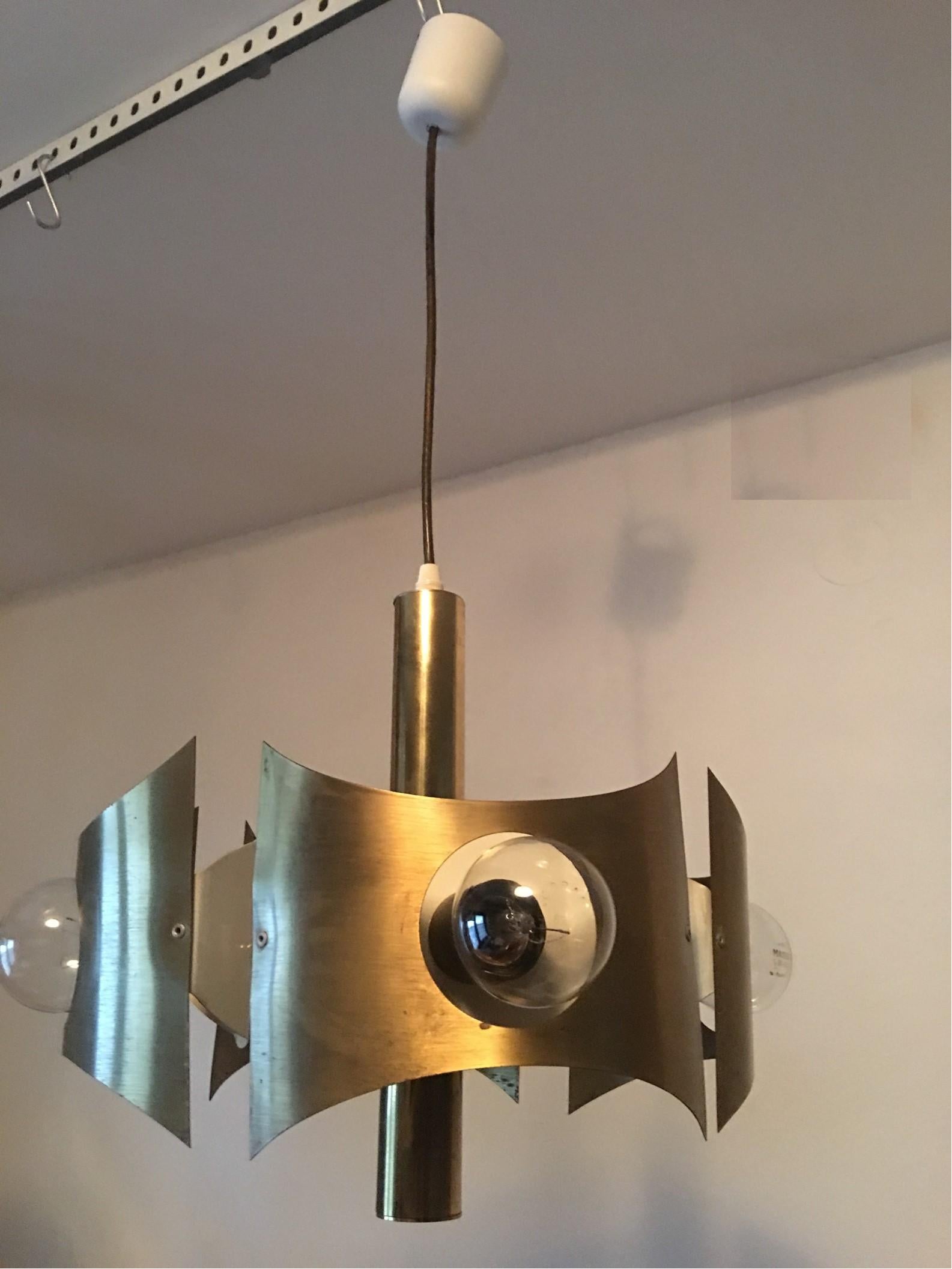 This beautiful Italian lamp has four brass compartments with a large opening in the middle for the bulb, it provides some amazing indirect lighting effects. There is some patina on the brass as expected with the age of the fixture. Clearly shown on
