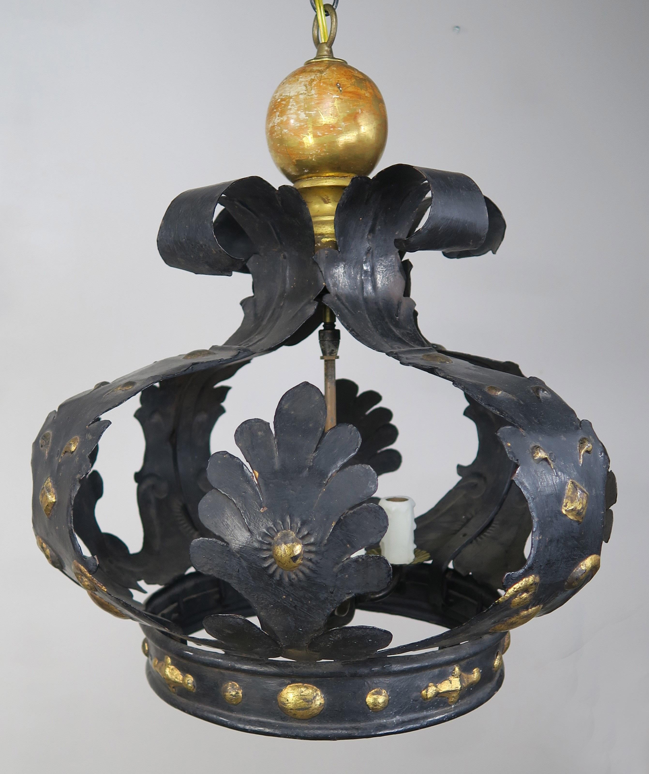 Italian 4-light tole and wood crown chandelier with gold accents throughout. The fixture was originally made for a bed canopy and still has the hooks where the fabric hung over the bed. The crown is now wired into a light fixture with chain and