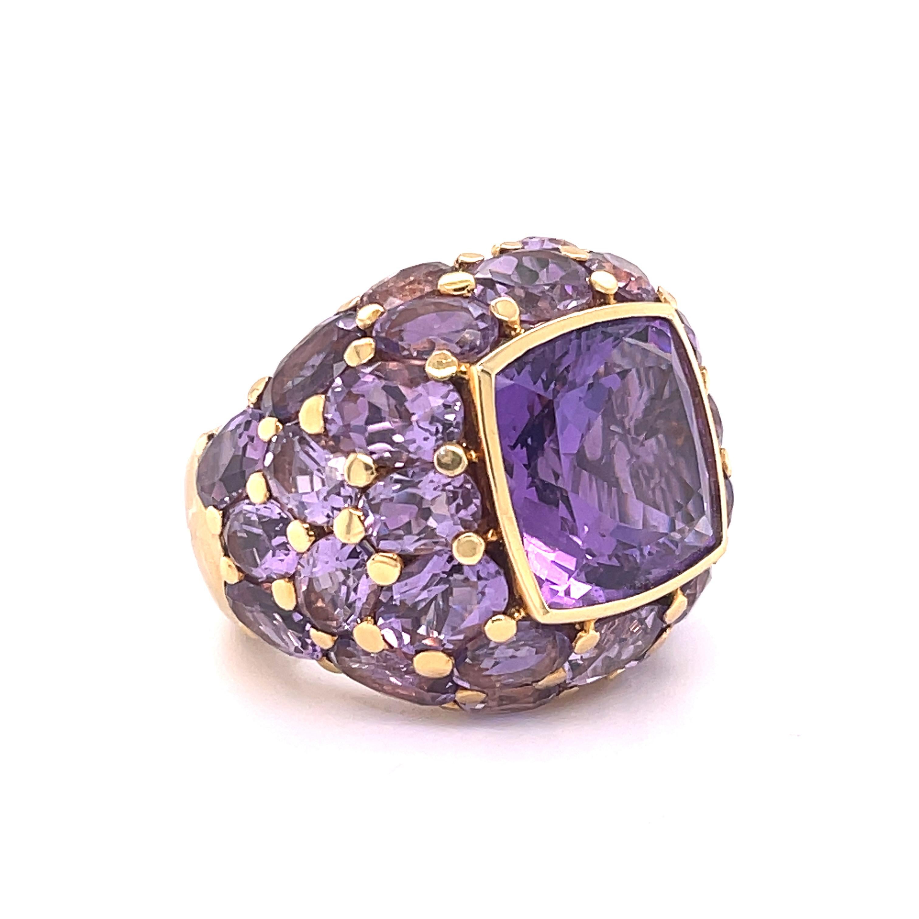 Large Amethyst center stone surrounded by round-cut amethysts on a yellow gold ring band. Perfect cocktail or fashion ring. 

• 50 Carats Amethyst 
• Hand made in Italy 
• Mimi 
• 18k Gold

Complimentary appraisal and ring resizing are available