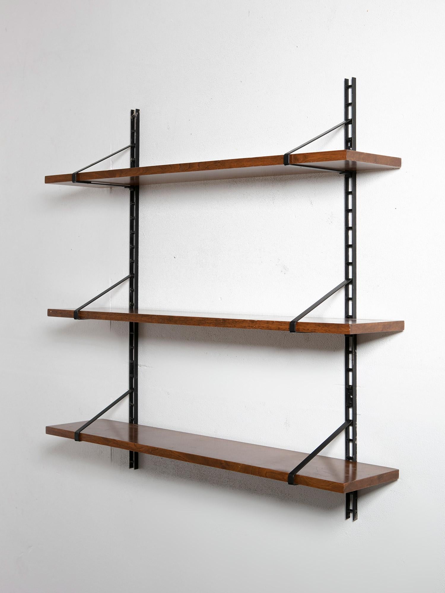 Modular wall shelving piece featuring two wall tracks and three adjustable shelves.