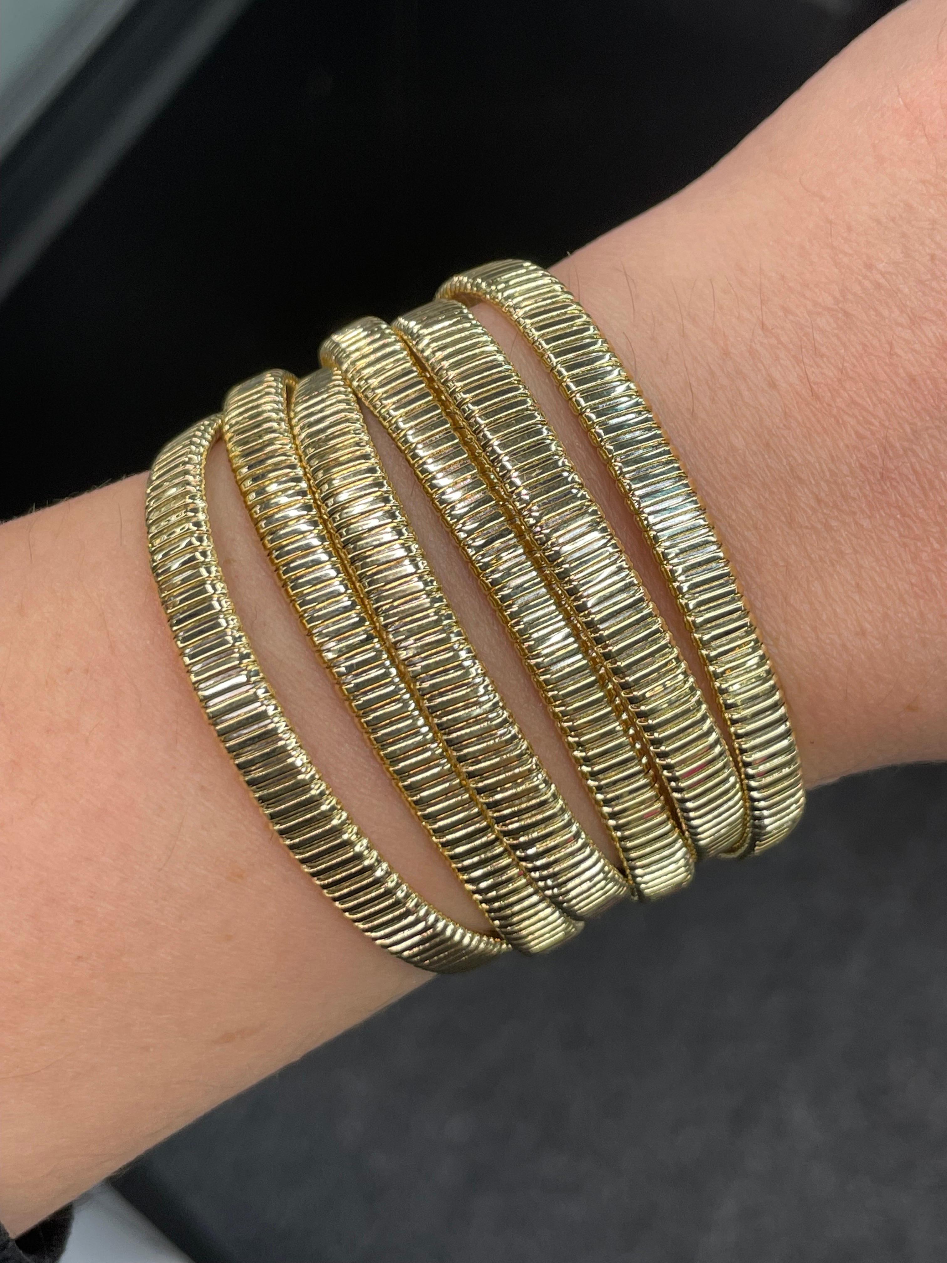 18 Karat Yellow Gold wide bracelet featuring 6 Tubogas rows weighing 48.9 Grams, Made in Italy.
Extremely comfortable on the wrist.
Larger version available.