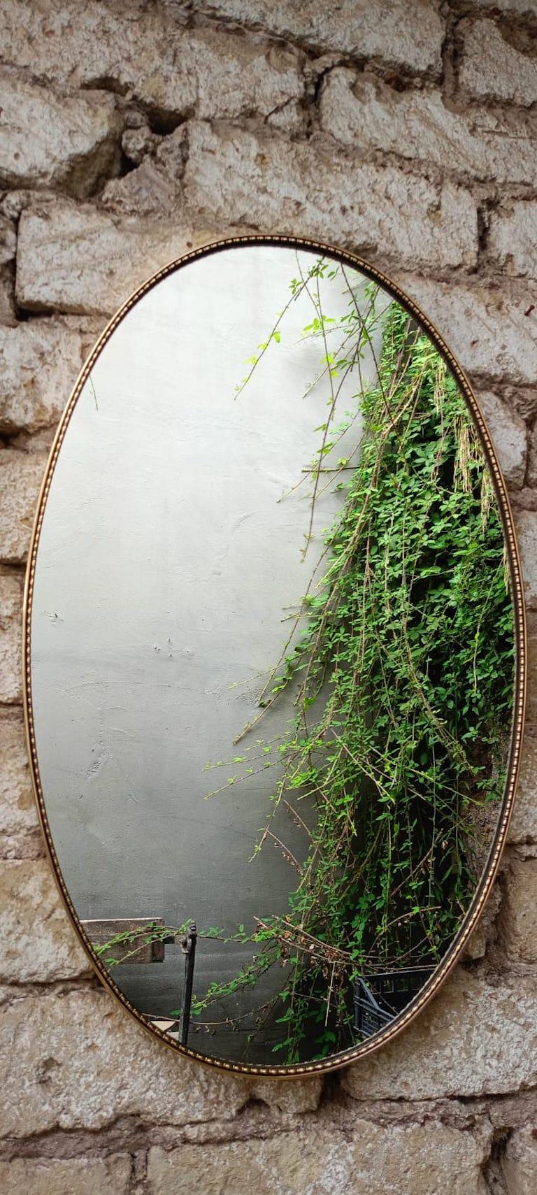 An oval brass frame mirror Italian c.60's