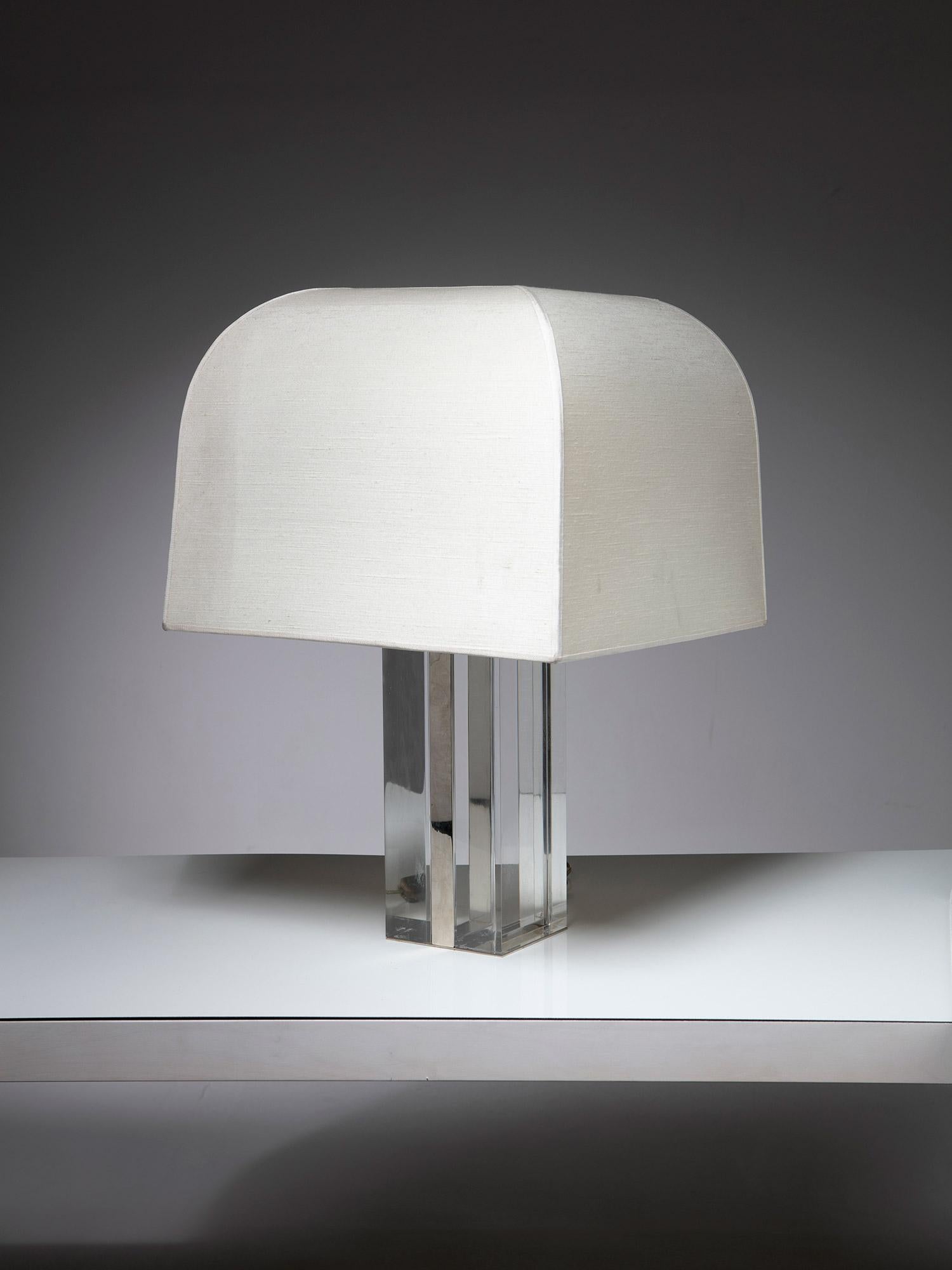Italian 1960s table lamp.
Large solid plexiglass base with chrome details and original textile shade.