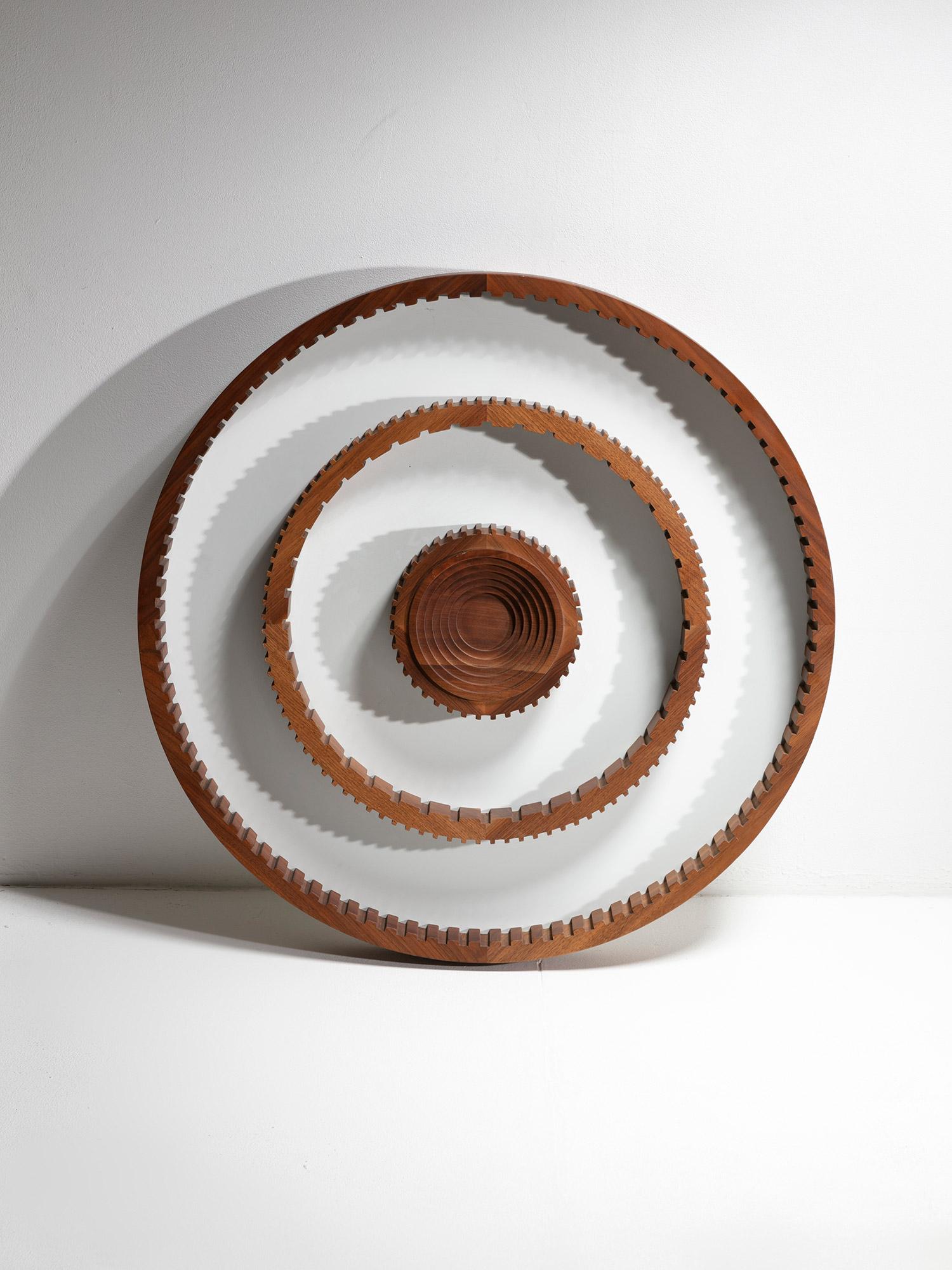 Italian 1970s round abstract wall sculpture.
Solid walnut cogwheels on white formica background generate a minimal mandala.