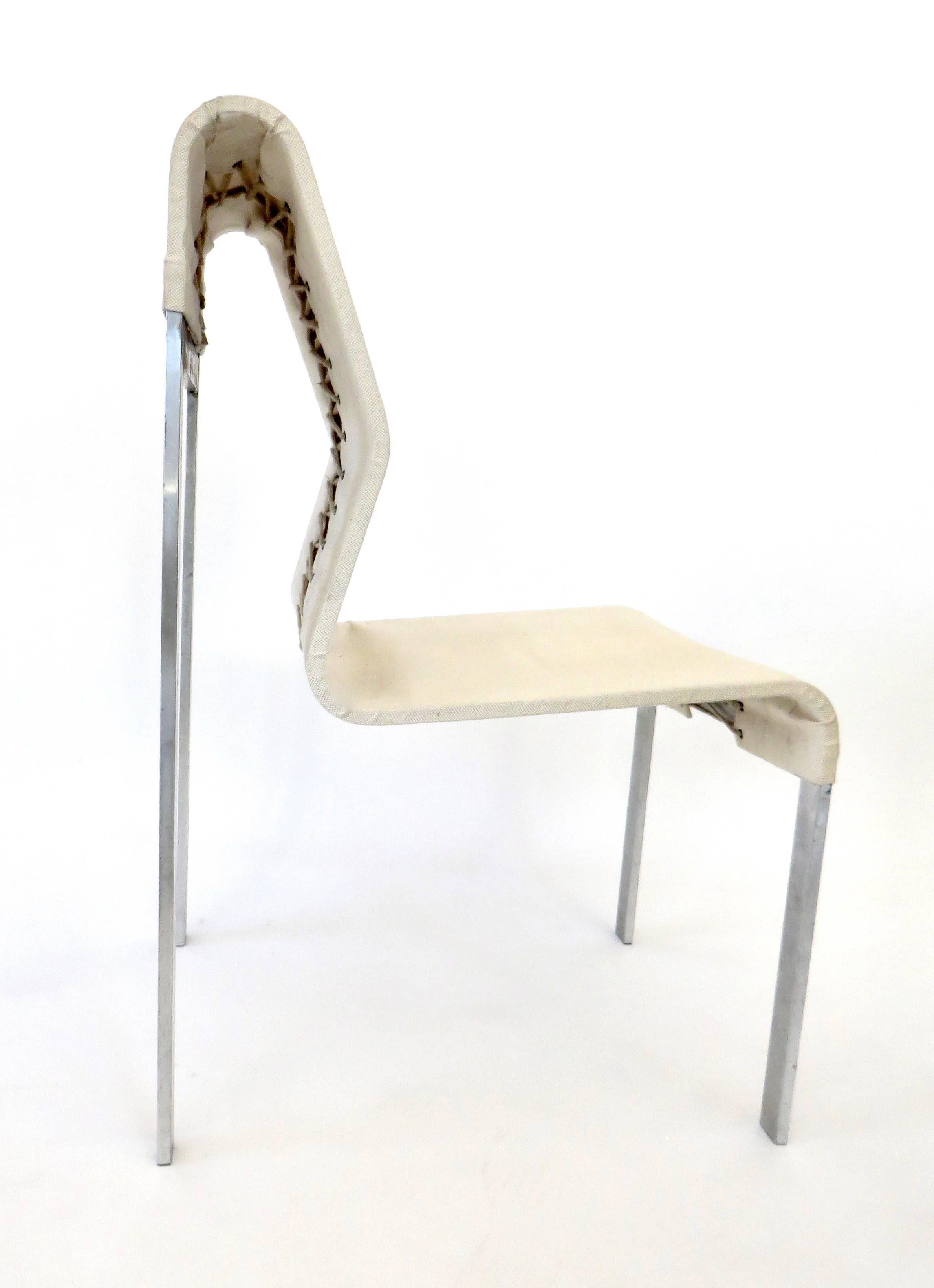 An Italian abstract strap steel and linen fabric side and statement chair.
The steel has been bent into an abstract sculptural shape with curves and folds. 
The fabric is a heavy linen tied in the back as a laced corset. 
Perfect for a fashion