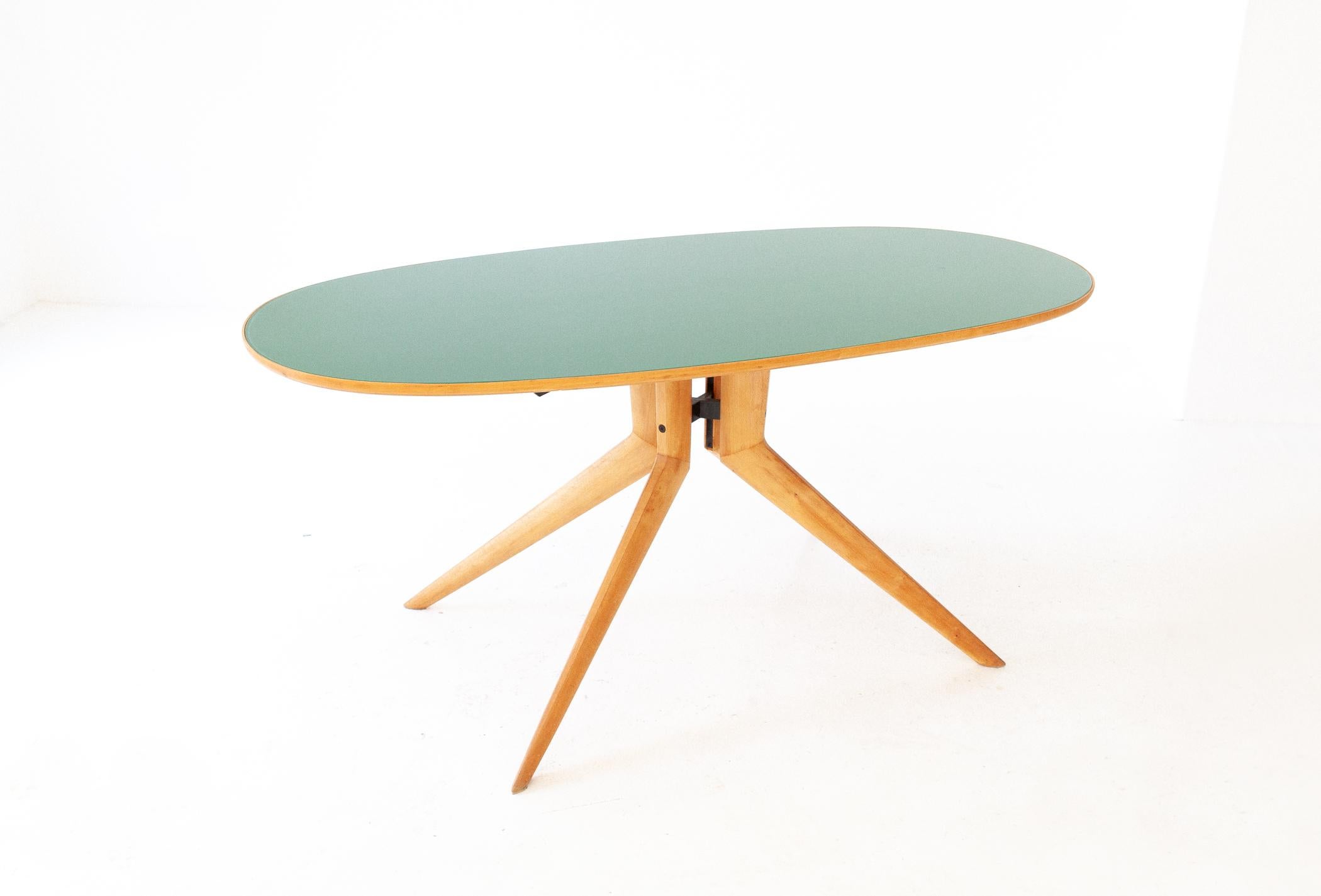 Semi- Oval dining table, acer wood, black enameled iron, light green glass top, Italy, 1950s 

It has a modern, technical and detailed style, typical of the Italian design of the 50s, attributable to Ico Parisi

Restoration: A complete