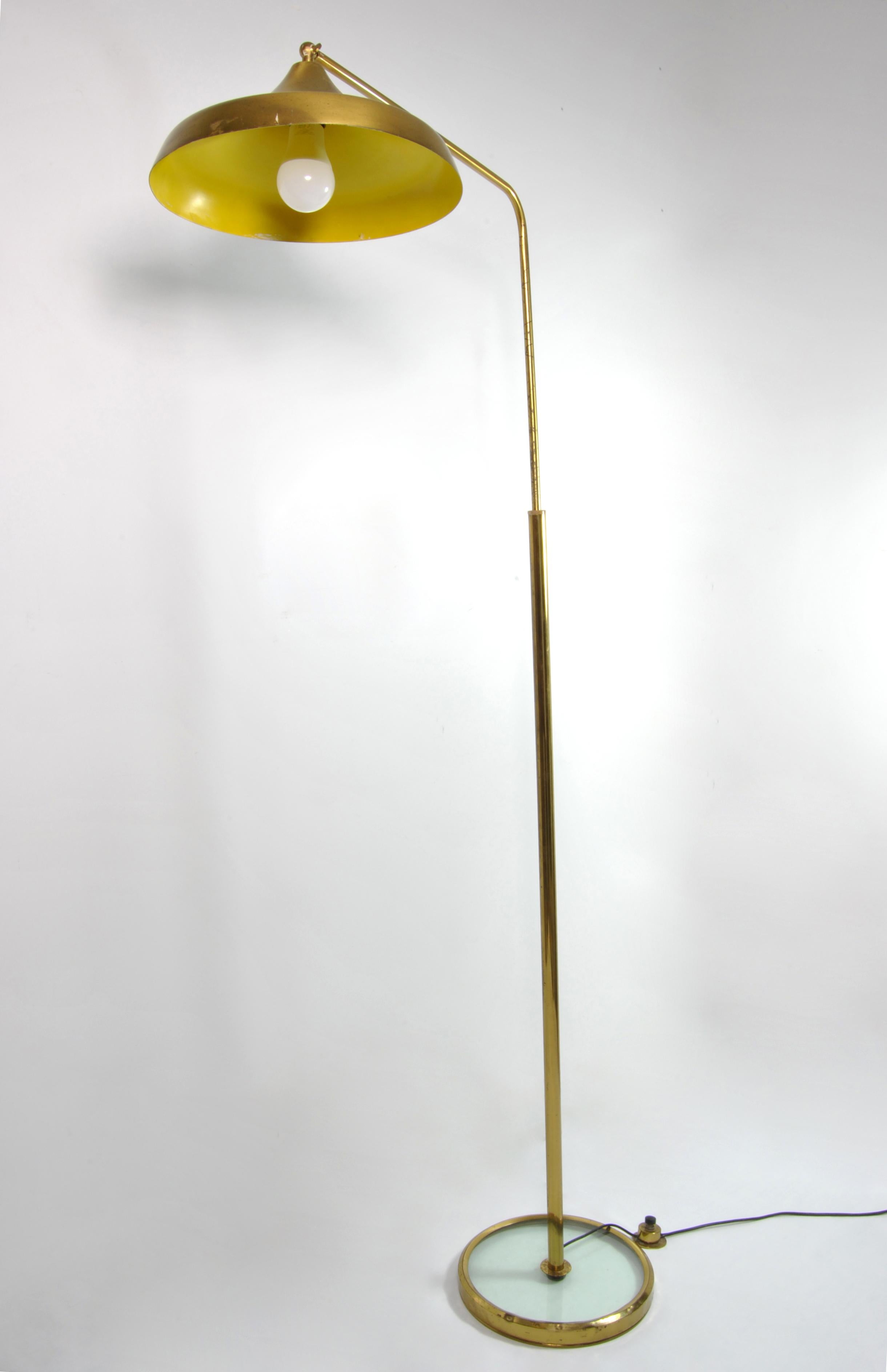 Italian adjustable floor lamp by Fontana Arte, 1960 with metal shade attached to arm and pole standing brass on a glass base.
Bibliography:
- 