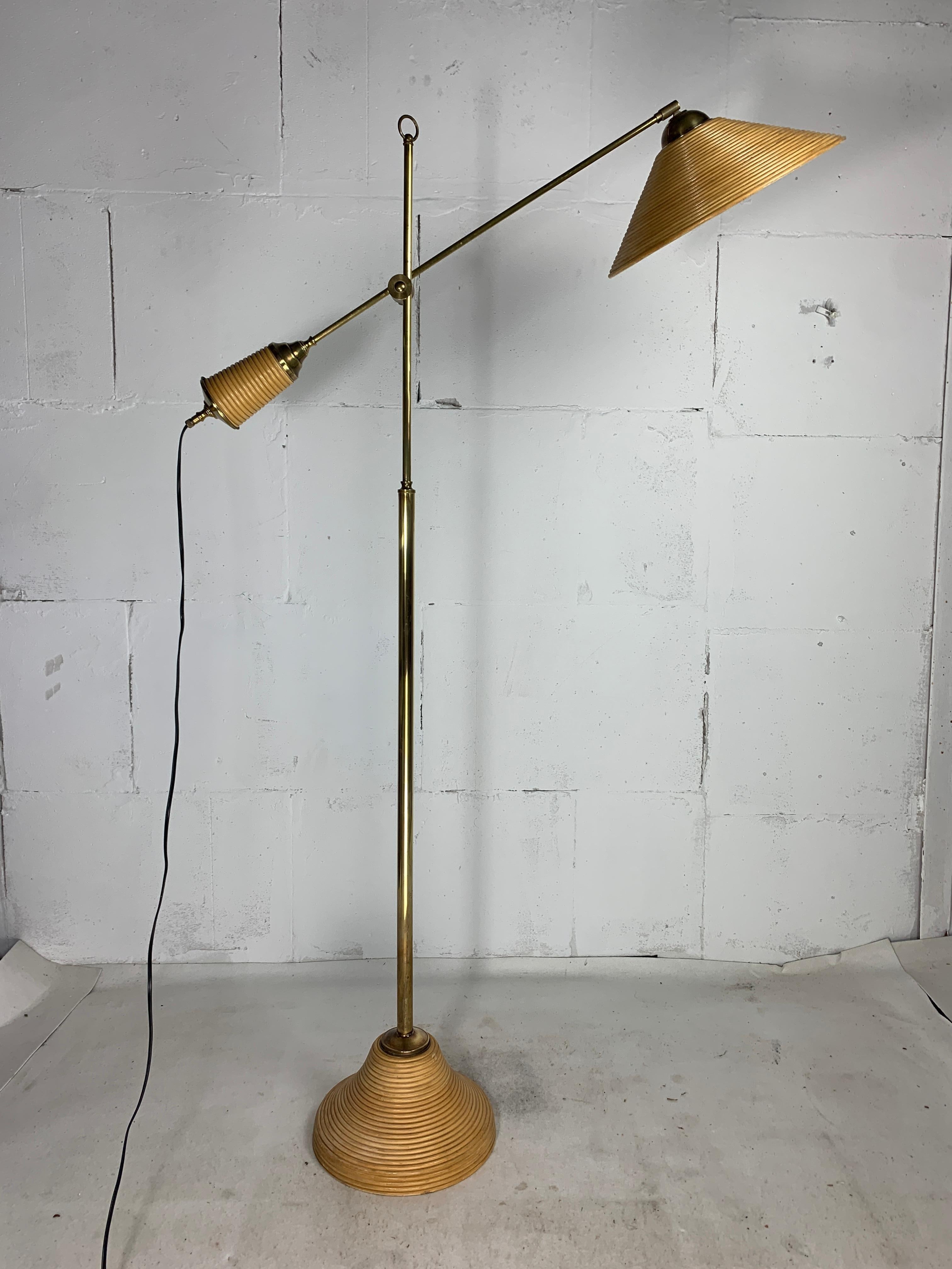 Here we have a lovely rattan and bamboo split or pencil reed floor lamp with brass. The combination of rattan and brass was made popular by Gabriella Crespi in the 1960s. These lamps are generally always attributed to Italy 1970s - 1980s ( and not