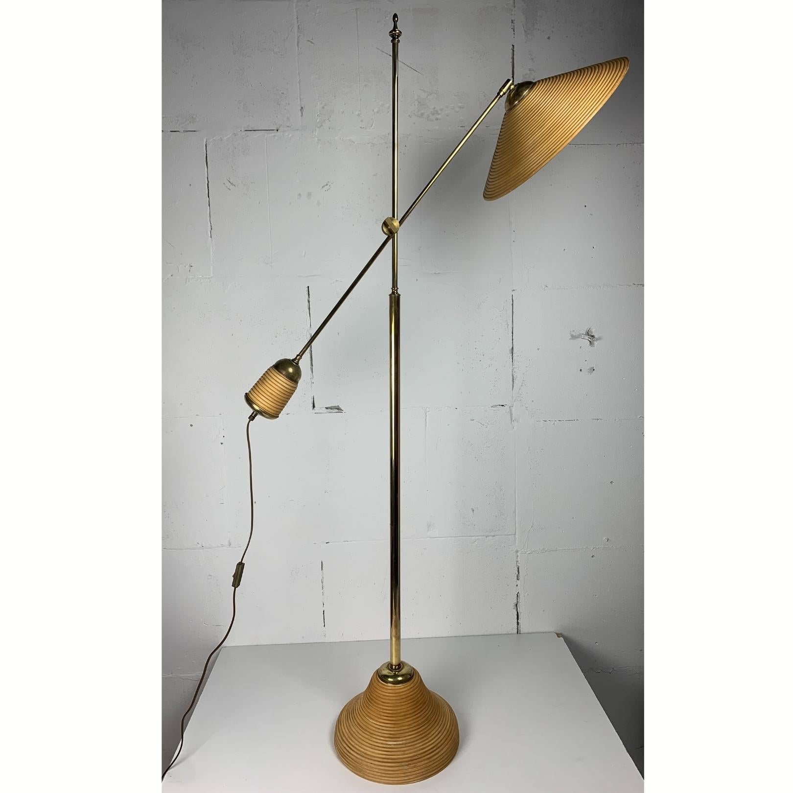 Here we have a lovely rattan and bamboo split or pencil reed floor lamp with brass. The combination of rattan and brass was made popular by Gabriella Crespi in the 1960s. These lamps are generally always attributed to Italy 1970s - 1980s ( and not
