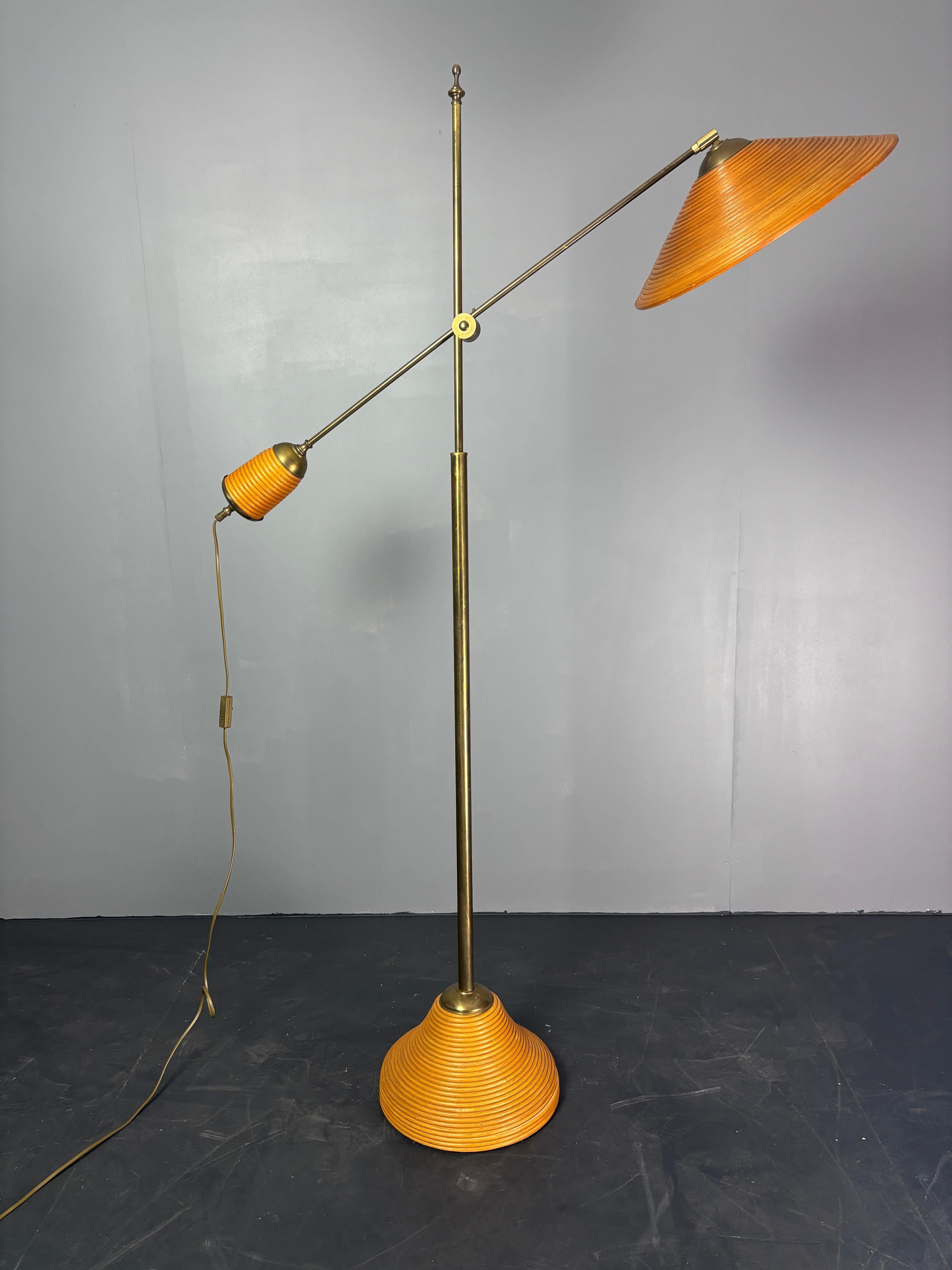 Here we have a lovely rattan and bamboo split or pencil reed floor lamp with brass. The combination of rattan and brass was made popular by Gabriella Crespi in the 1960s. These lamps are generally always attributed to Italy 1970s - 1980s ( and not