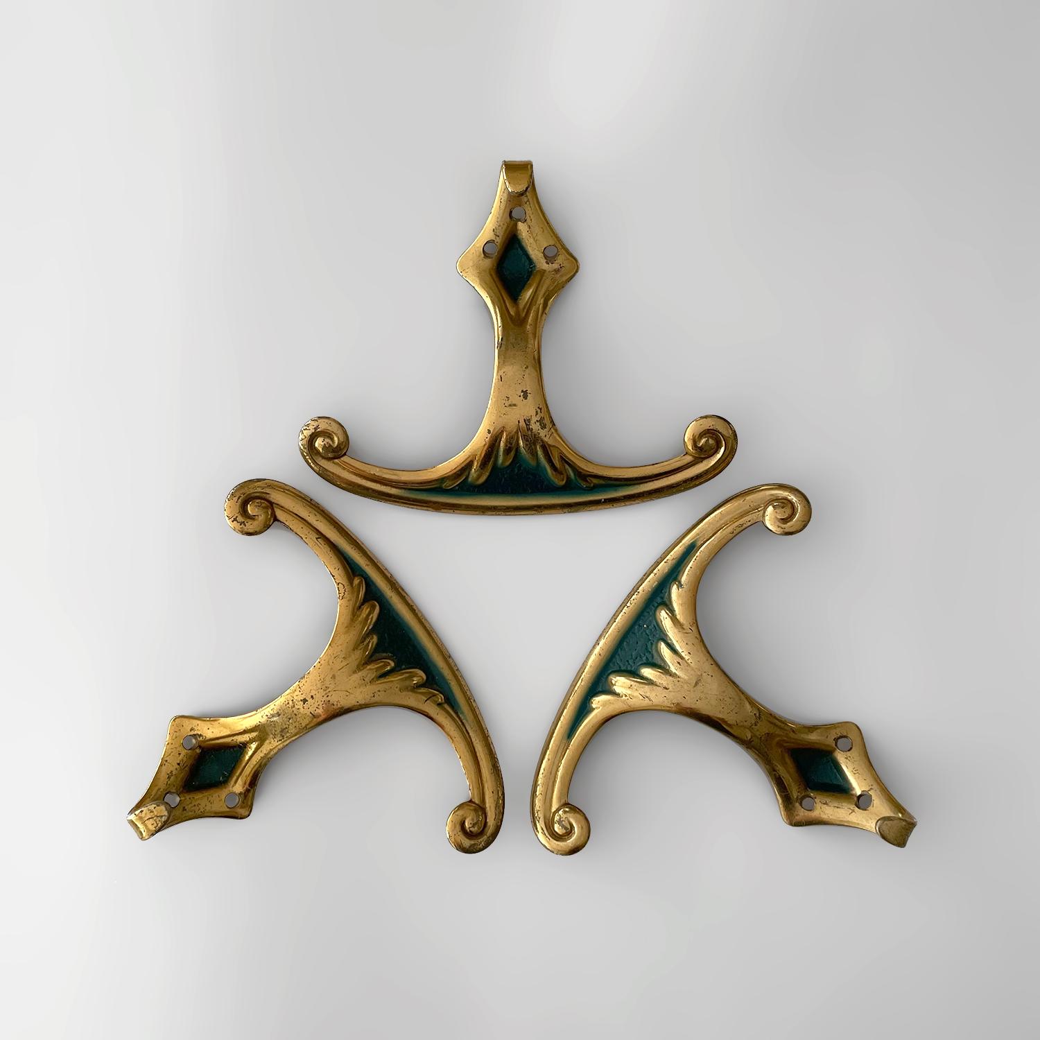 Italian aged brass wall hooks
Italy, circa 1950s
Each hook provides plenty of storage with an upper arched wide panel hook and a lower j hook
Rich dark green accents are perfectly contrasted against the aged brass backdrop
Metal has some loss,