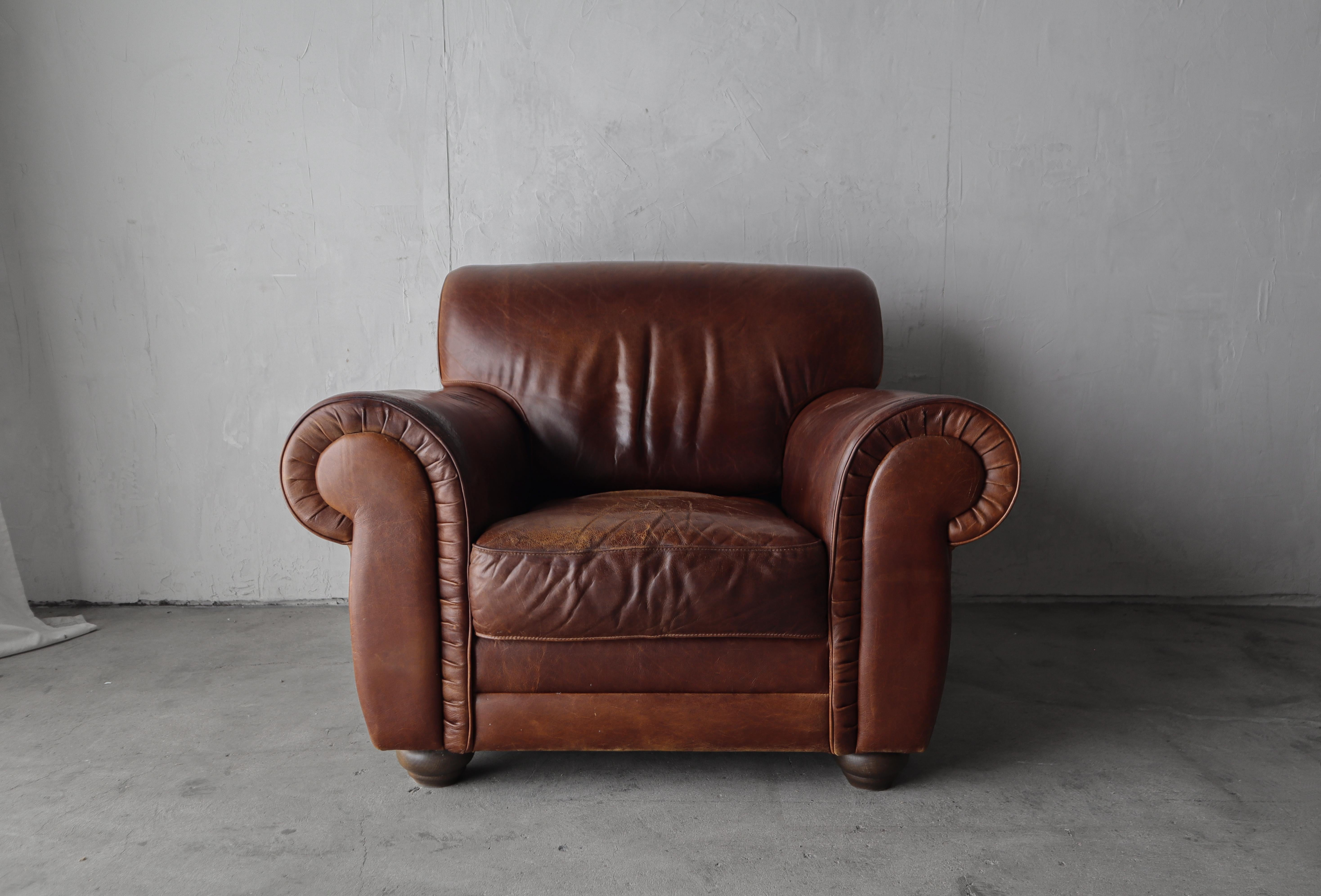 This is the ultimate vintage leather club chair and ottoman. Made in Italy, this patinated leather club chair is the epitome of perfect worn leather chairs. This combo features the kind of patina that money can't buy, the kind that only comes with
